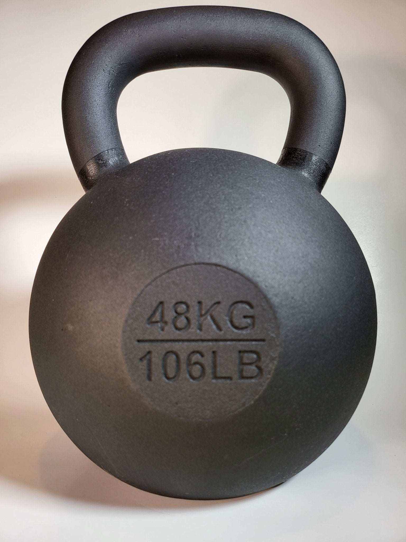 Powder coated kettlebell with textured grip and color-coded handle