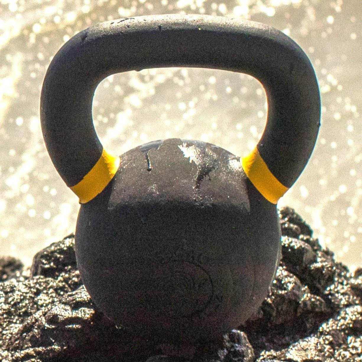 Powder coated kettlebell with textured grip and color weight indicators
