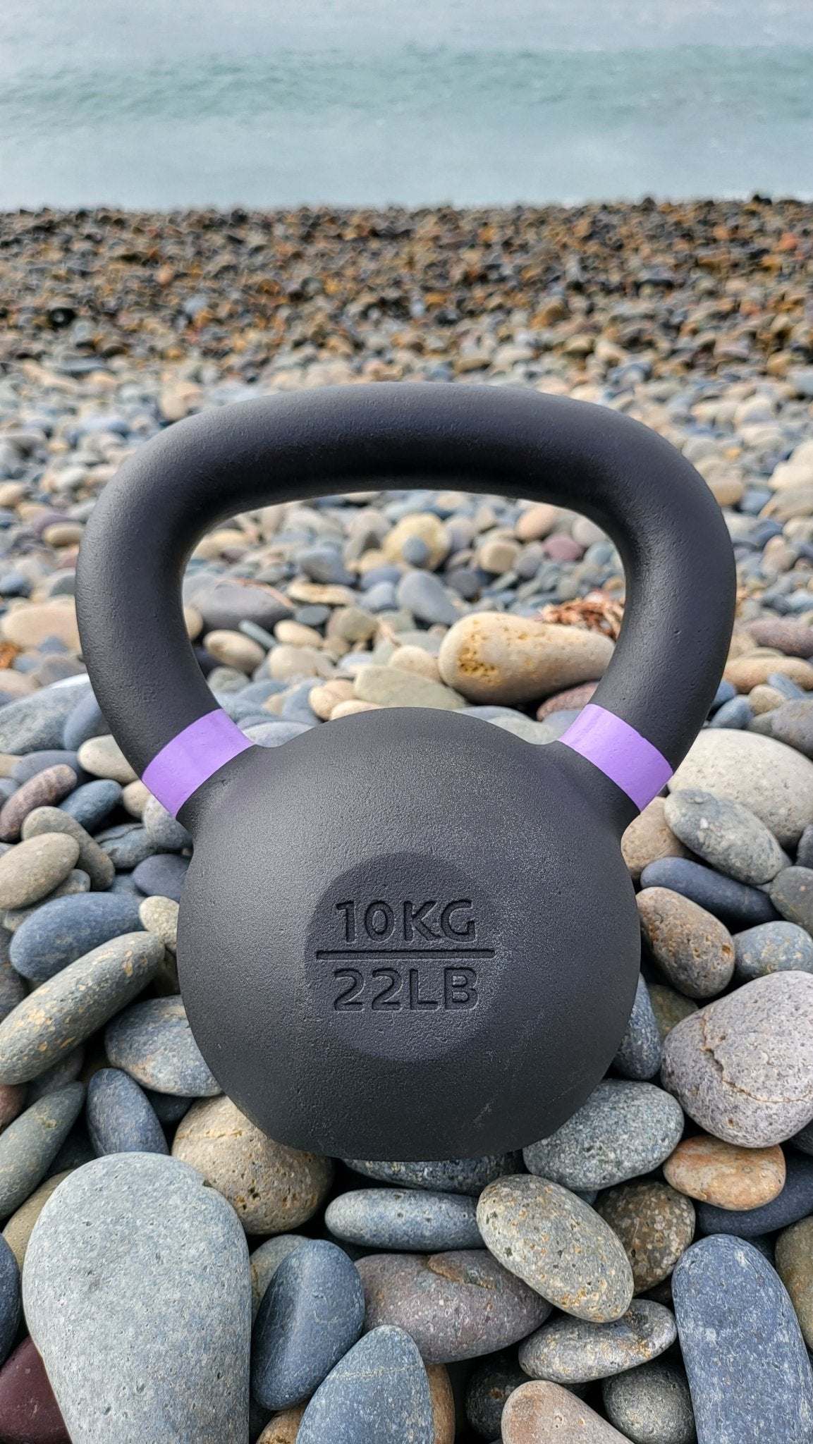 Powder coated kettlebell with textured grip and color weight indicators