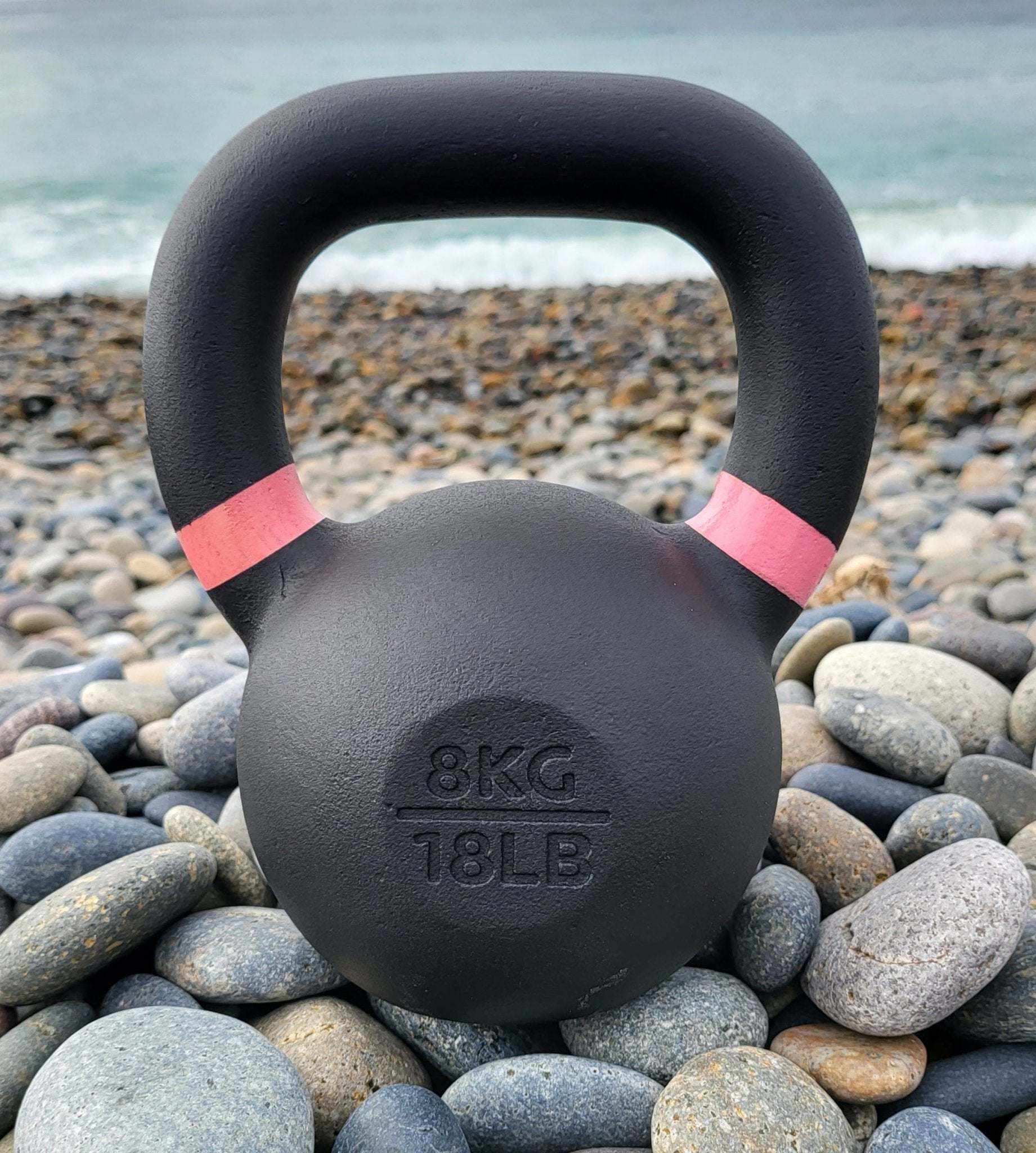 Powder coated cast iron kettlebell with color weight indicators and smooth finish