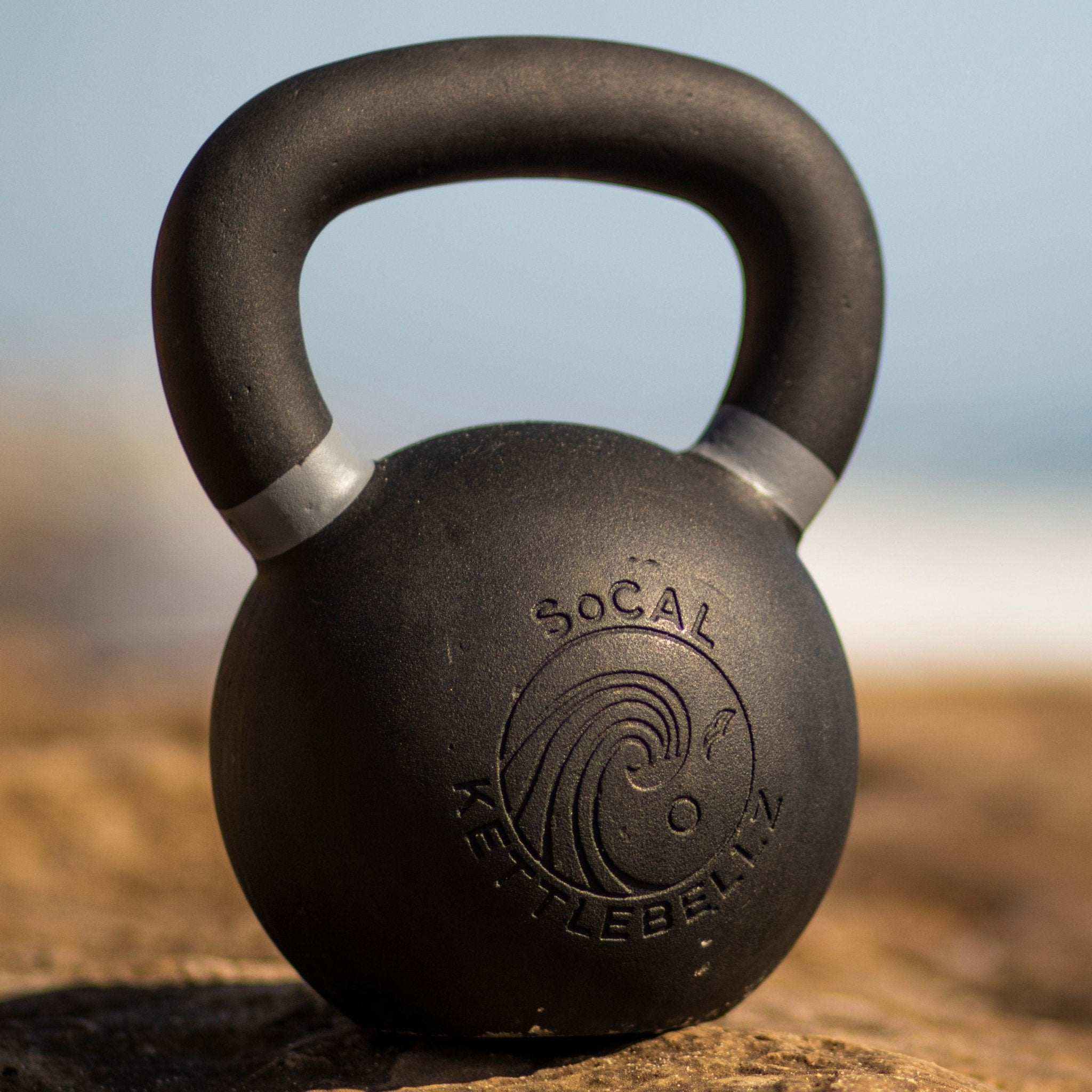 Powder coated kettlebell with textured grip and color weight indicators