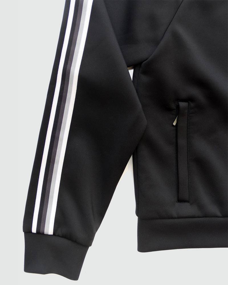 Powerstripe LS Track Jacket in black smooth fabric with twin white sleeve stripes, ribbed cuff and hem, and side pocket.