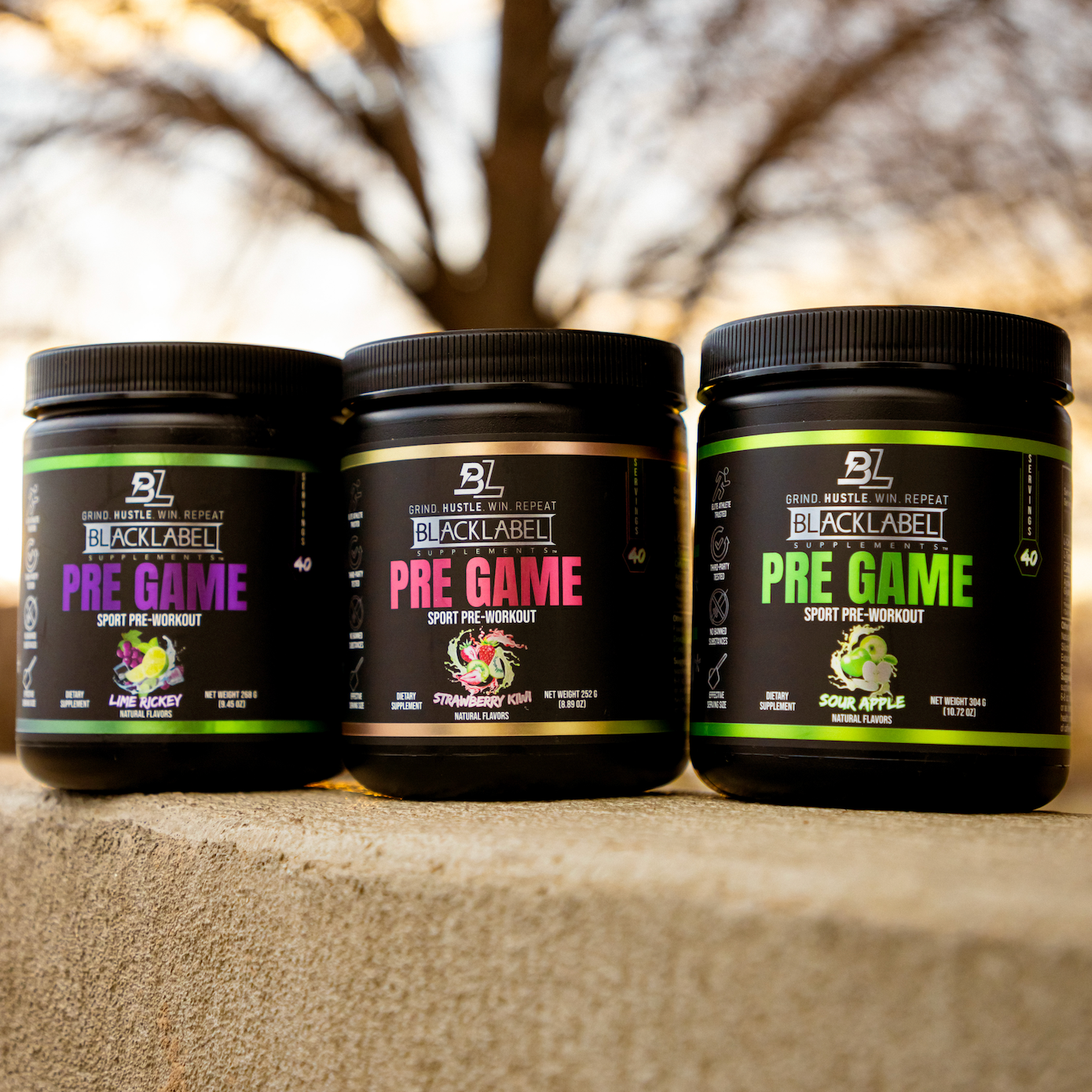 PRE GAME sport pre-workout powder jars in black tubs with purple, pink and green labels and fruit graphics