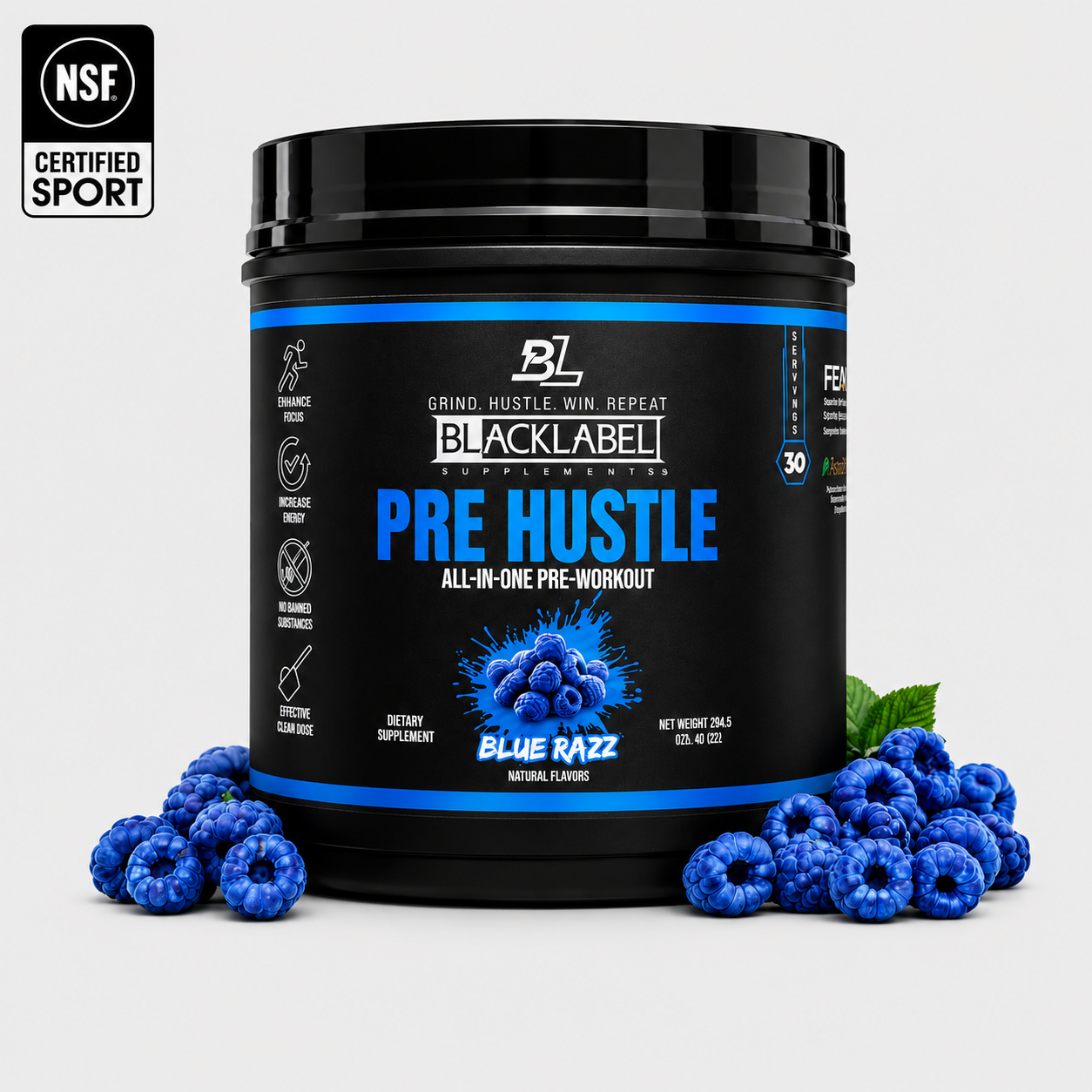 Black tub of PRE HUSTLE Pre-Workout supplement with blue raspberry flavor label surrounded by fresh blue raspberries and green leaves
