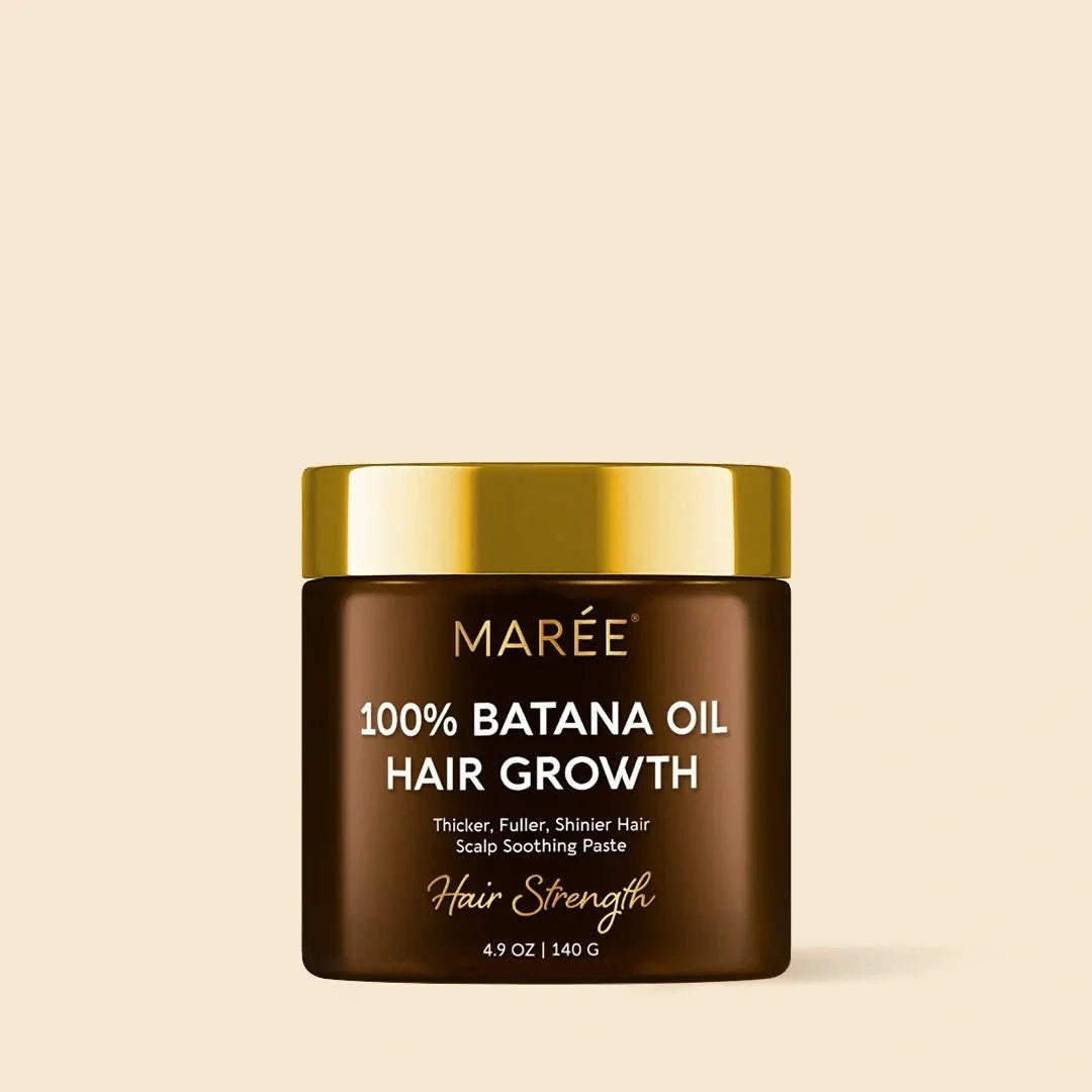 Pure Batana Hair Growth Paste in a dark brown jar with a gold lid and white hair growth labeling