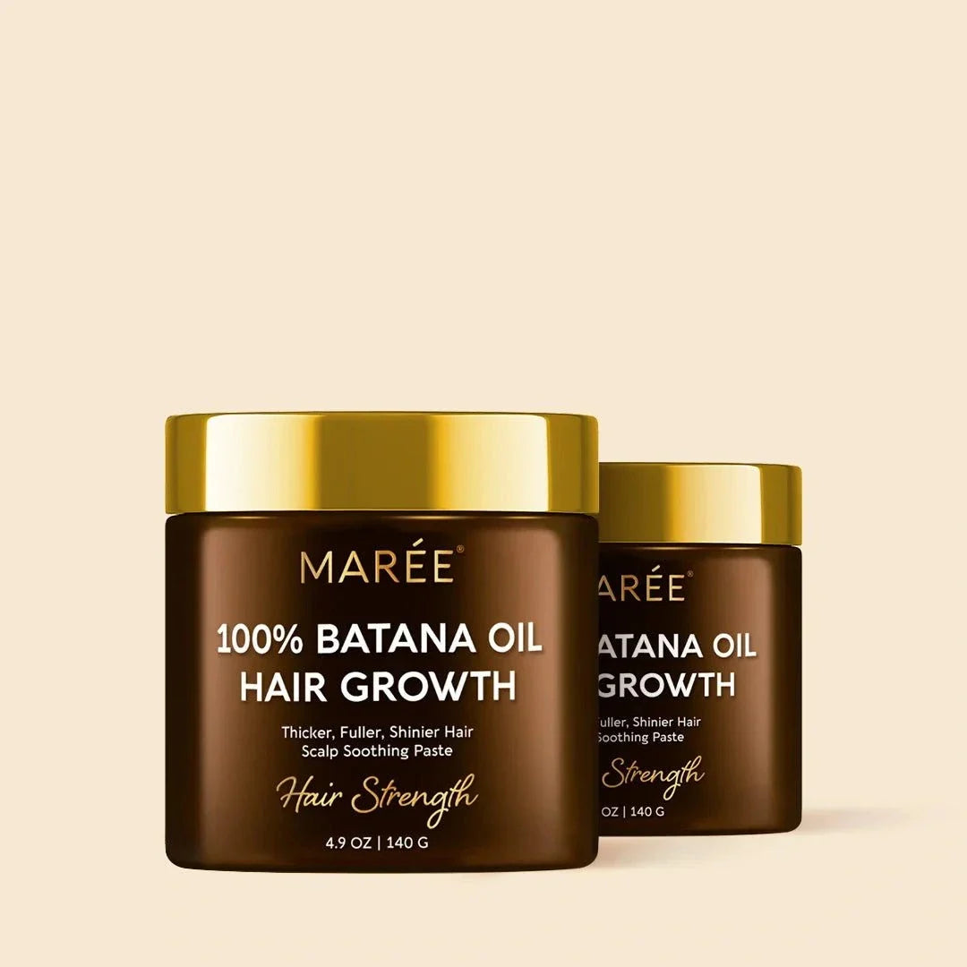 Pure Batana Hair Growth Paste in two dark brown jars with shiny gold lids and hair growth labels