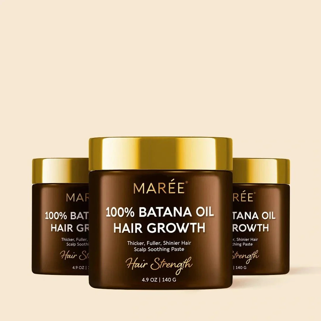 Pure Batana Hair Growth Paste in brown jars with glossy gold lids and white and gold label text