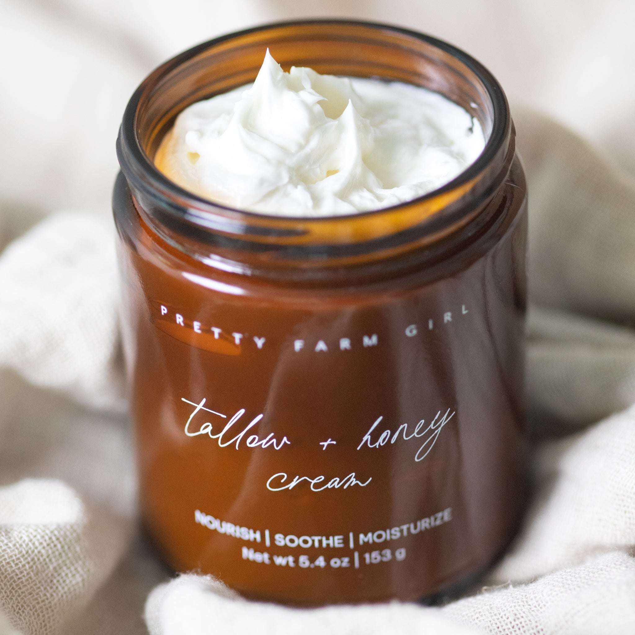 Pure + Simple Skin Kit tallow and honey cream in an amber glass jar, white whipped texture