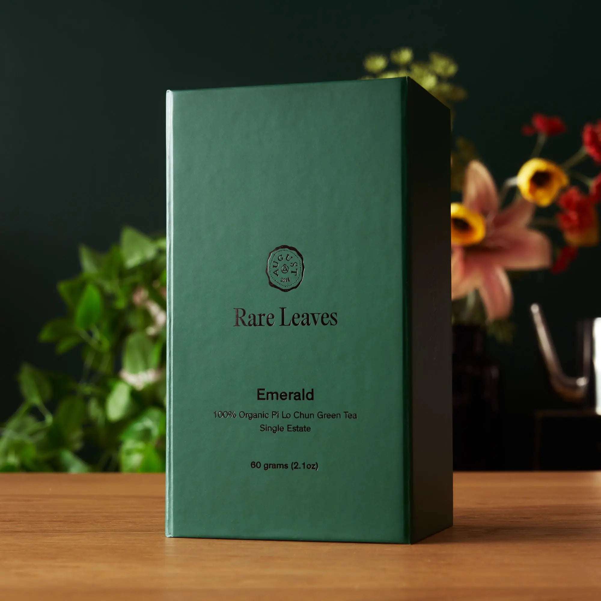 Rare Leaves Emerald - Pi Lo Chun Green Tea in a green paper box, featuring minimalist black lettering and logo