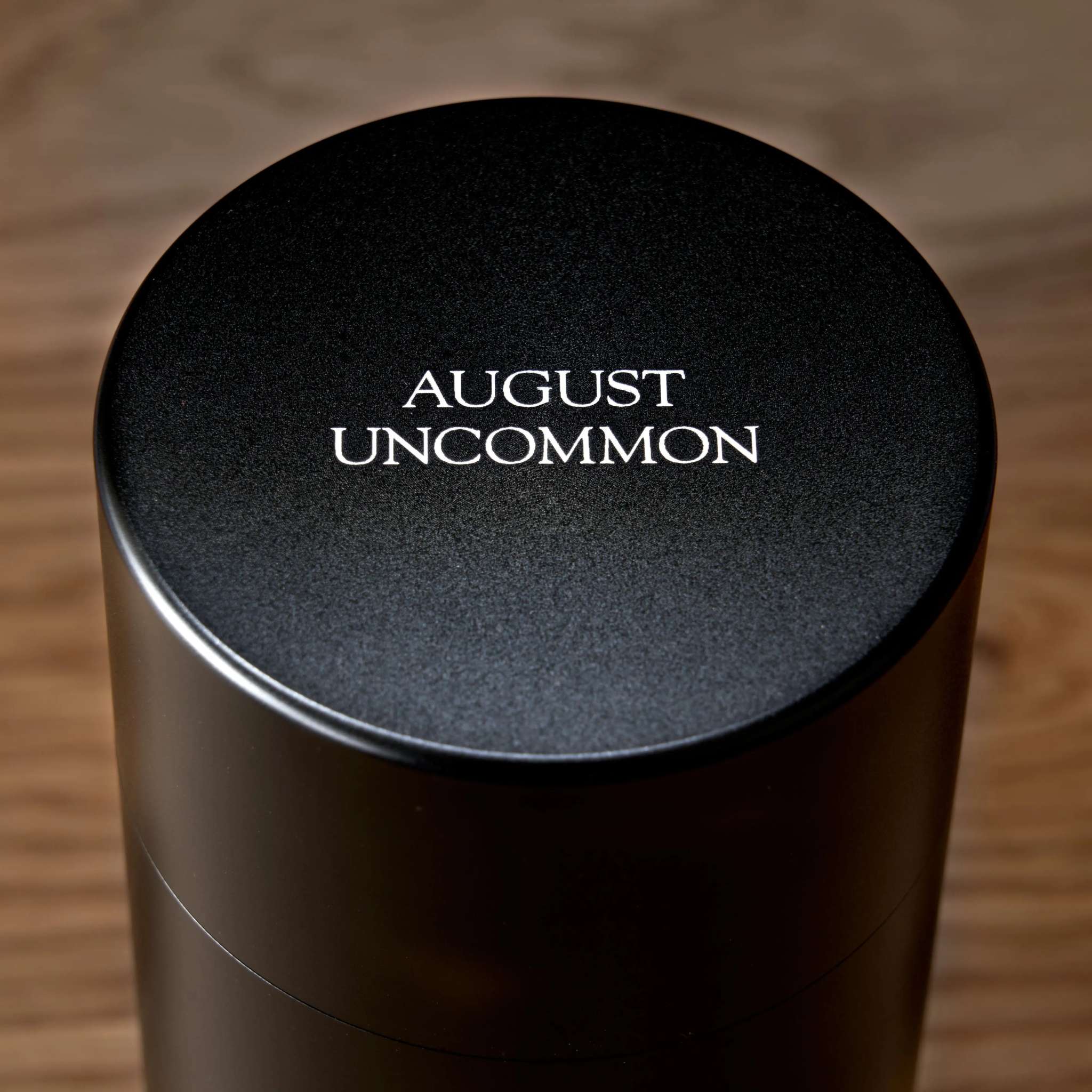 Rare Leaves Emerald - Pi Lo Chun Green Tea in a dark metallic cylindrical tin with black lid and white branding