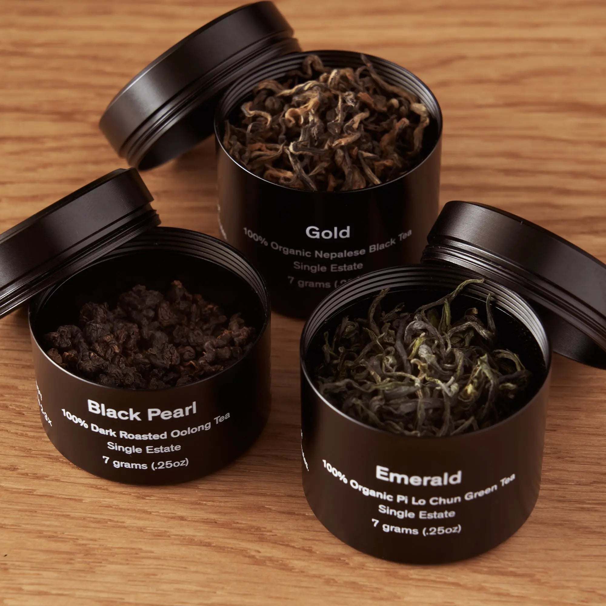 Rare Leaves Single Origin Tea Mini Tin Sample with three black aluminum tins of loose-leaf teas
