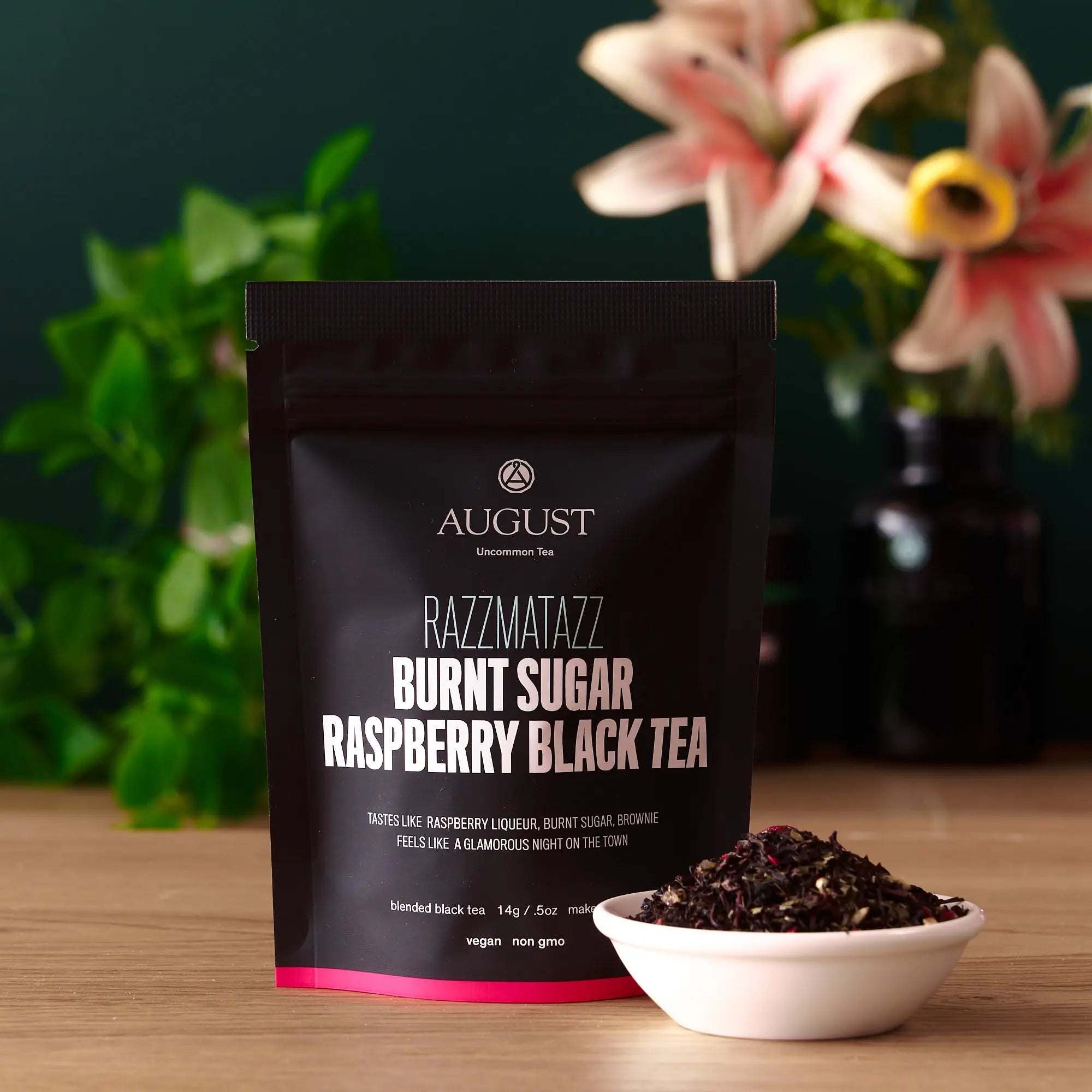 Razzmatazz - Raspberry Burnt Sugar Black Tea black tea pouch with raspberry blend and loose leaves in a white bowl