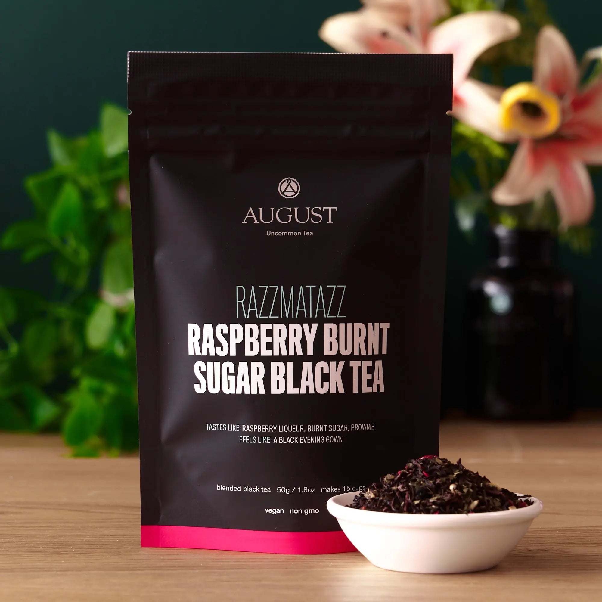 Razzmatazz - Raspberry Burnt Sugar Black Tea in a dark resealable pouch with raspberry burnt sugar tea leaves