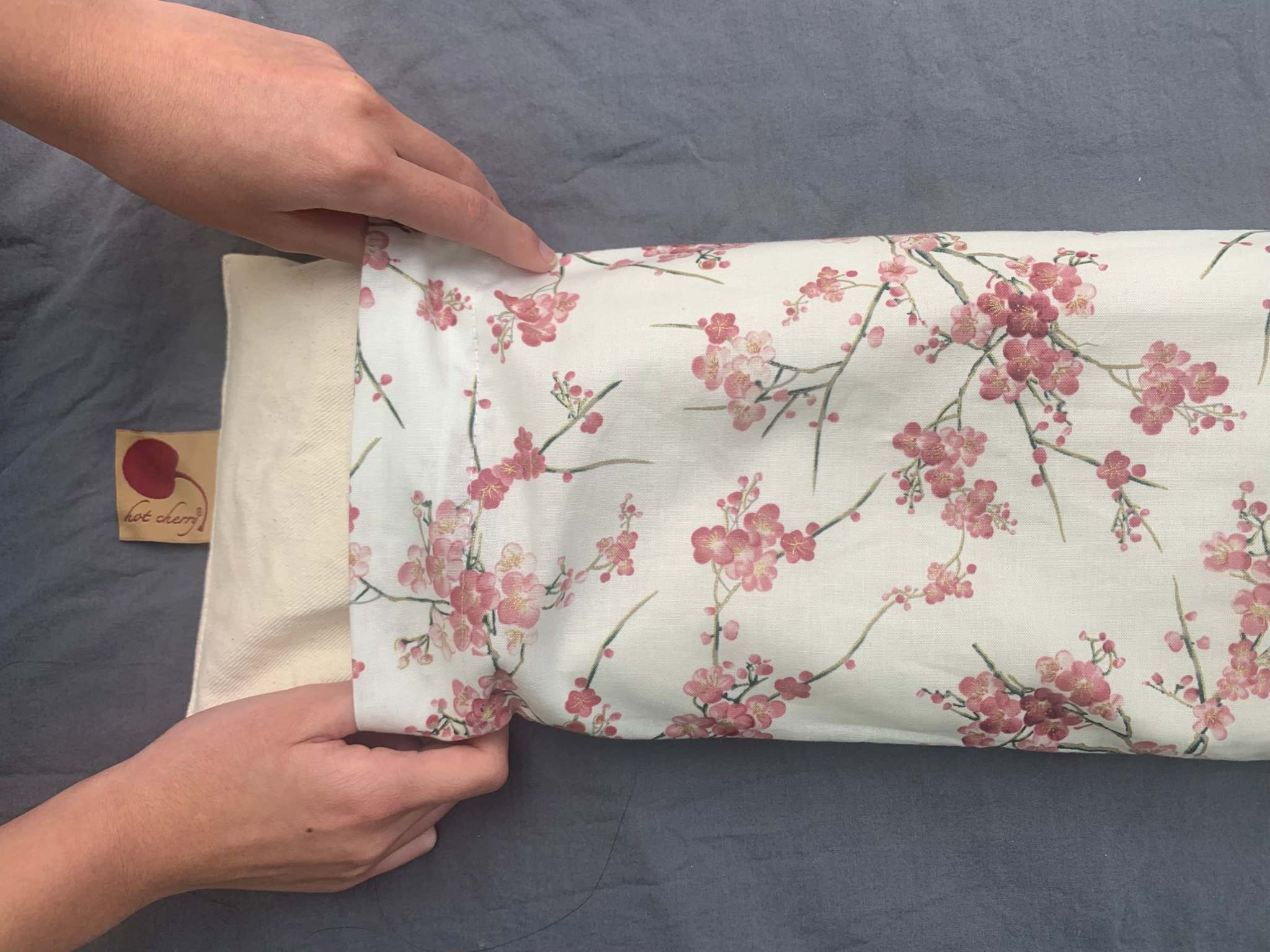 Rectangle/Cervical Pillow with a cream cherry blossom print cotton cover, shown beside its unbleached natural denim pillow