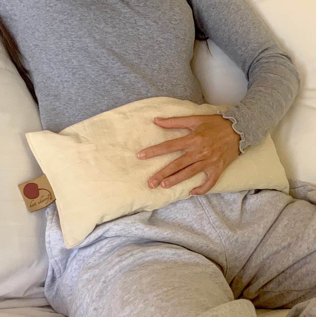 Rectangle/Cervical Pillow in cream unbleached fabric, rectangular shape with a small cherry tag and plain finish