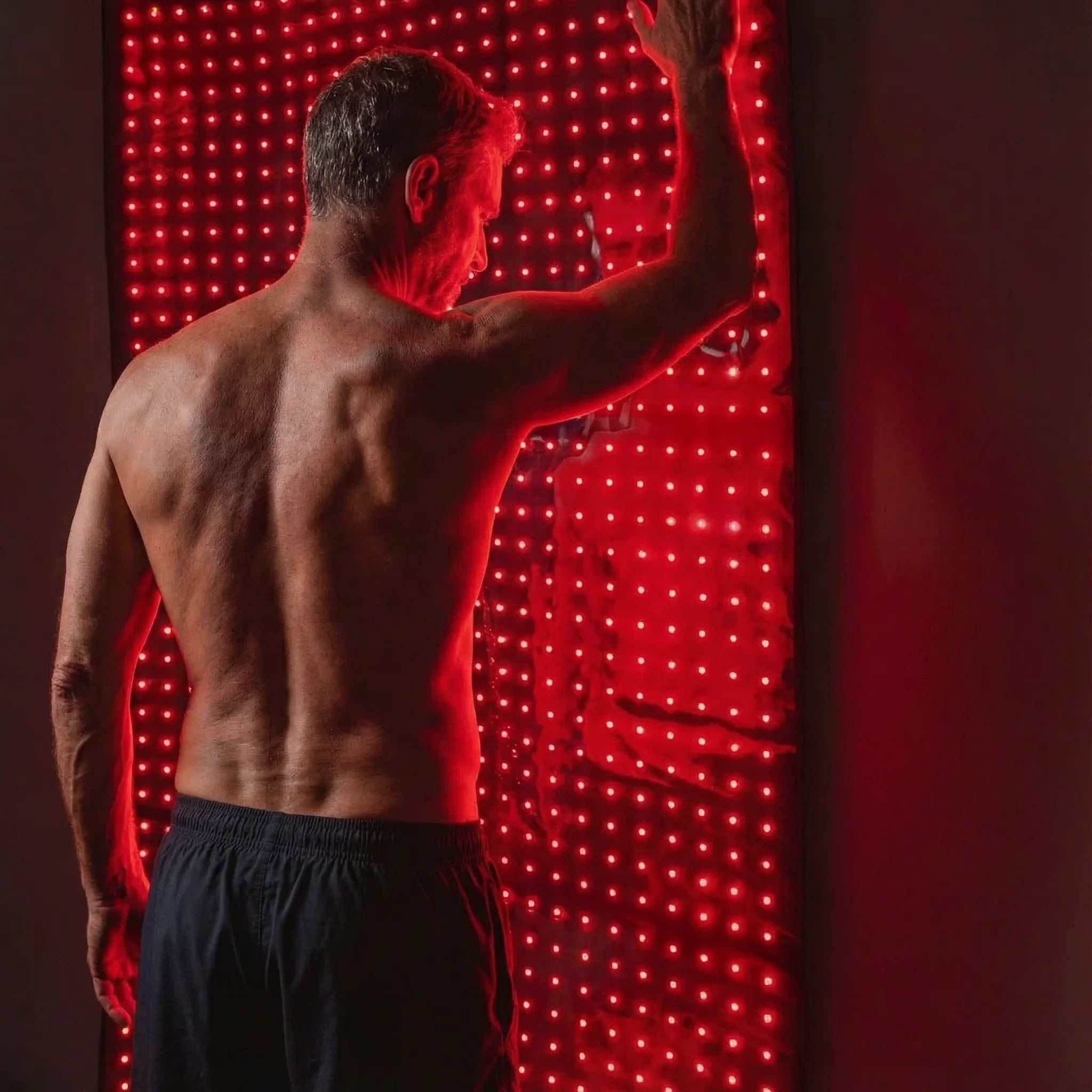 Red Light Therapy Mat with red LED lights illuminating a full-body wellness panel for targeted light therapy