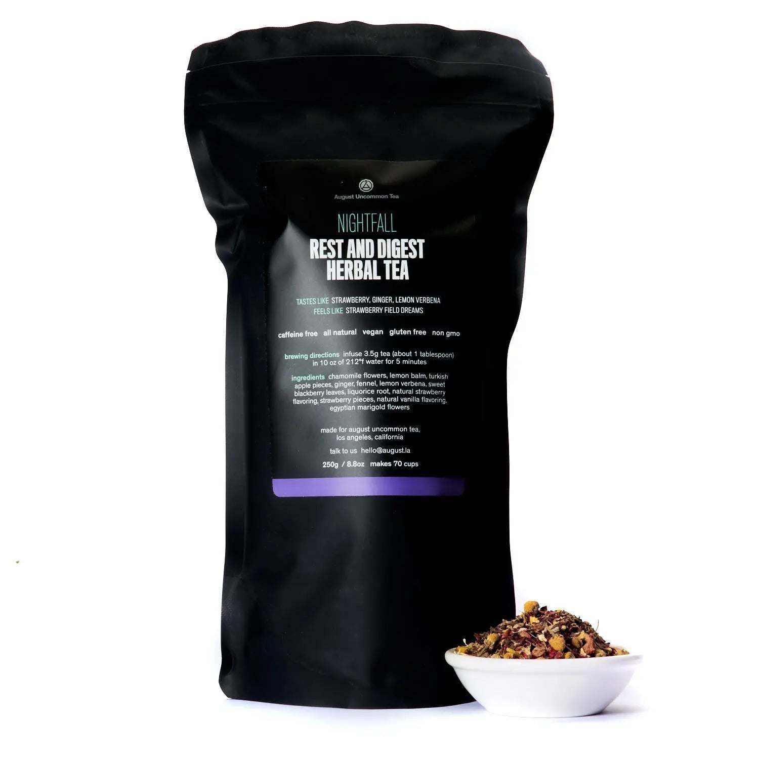 Rest and Digest Herbal Tea in a black Nightfall pouch with a bowl of loose herbal tea blend beside it