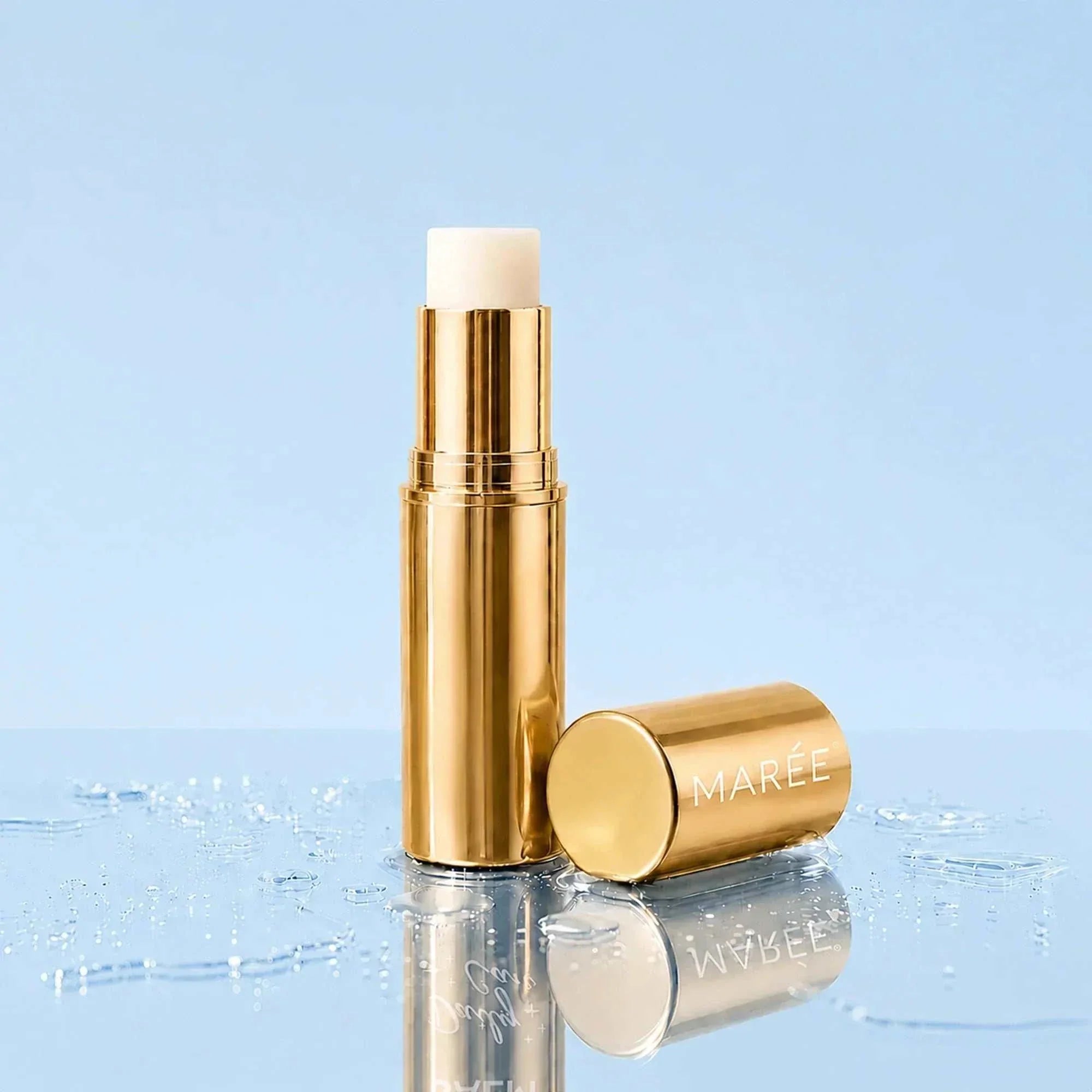 Retinol Under Eye Brightener in a gold balm stick with a white tip and matching gold cap