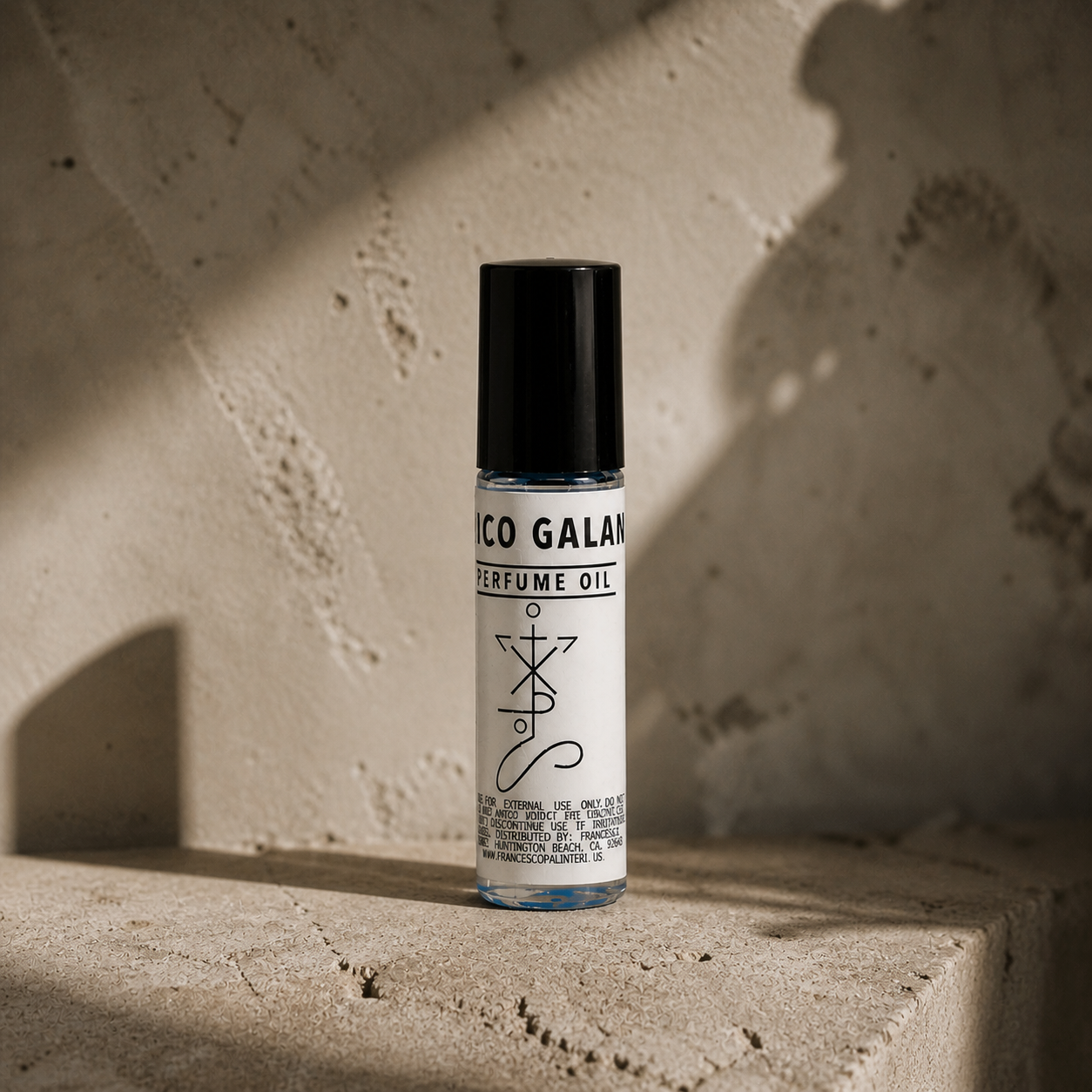 Rico Galan - Earthy Blend perfume oil roll-on in a white cylindrical bottle with a black cap and blue accents