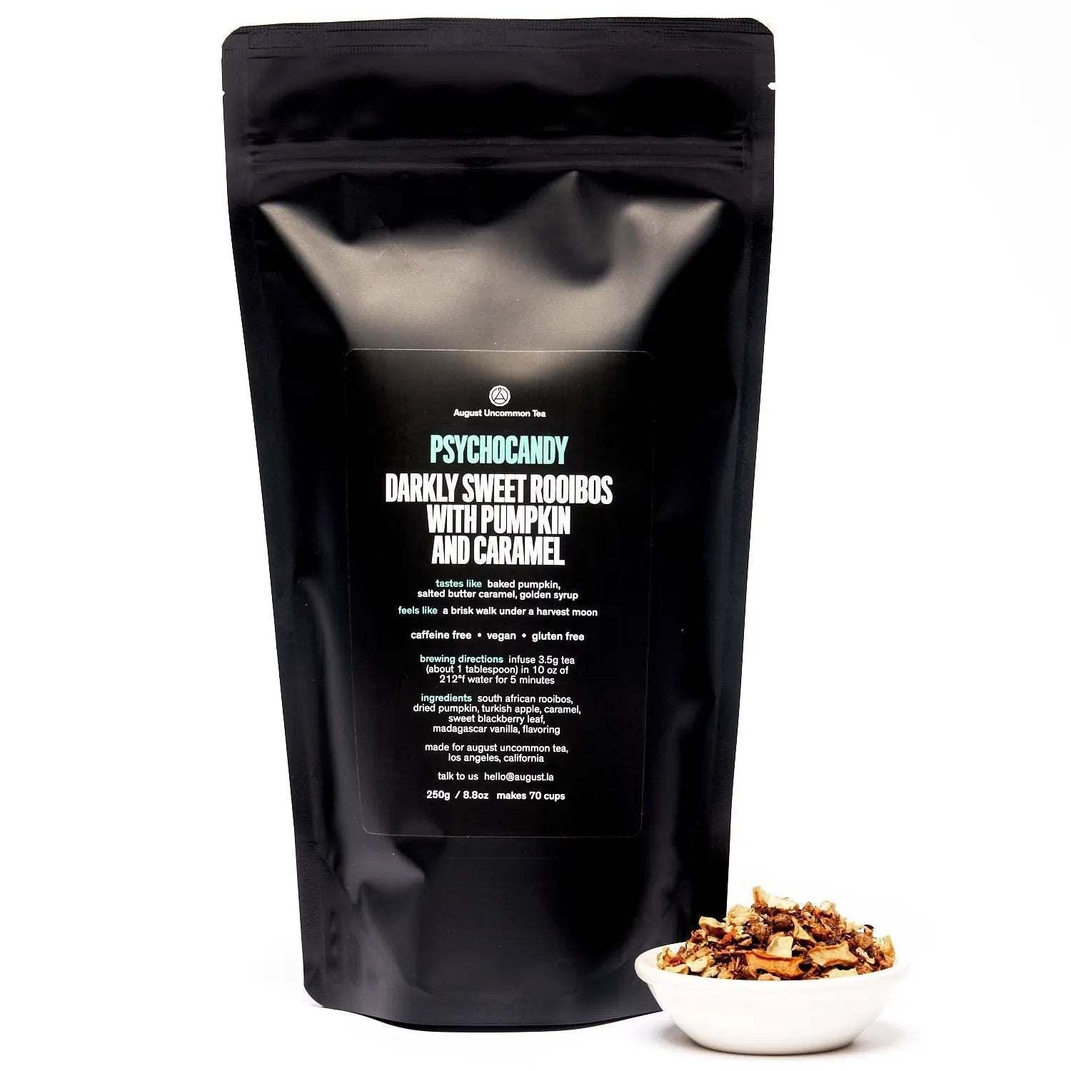 Roasted Pumpkin Caramel Rooibos Tea in a black Psychocandy pouch with a bowl of loose pumpkin tea blend