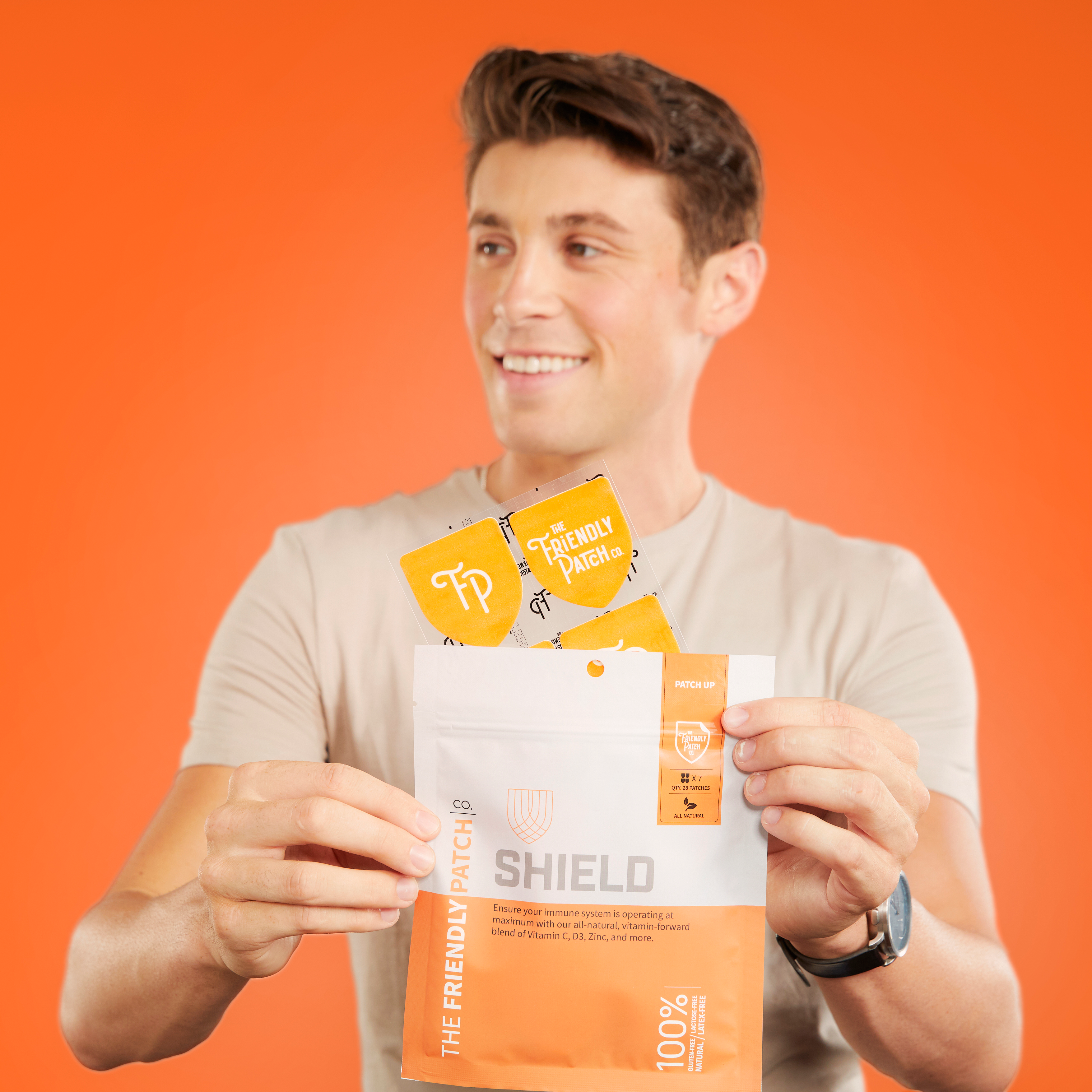 Shield Wellness Patches in orange packaging with individual Friendly Patch sachets and shield branding