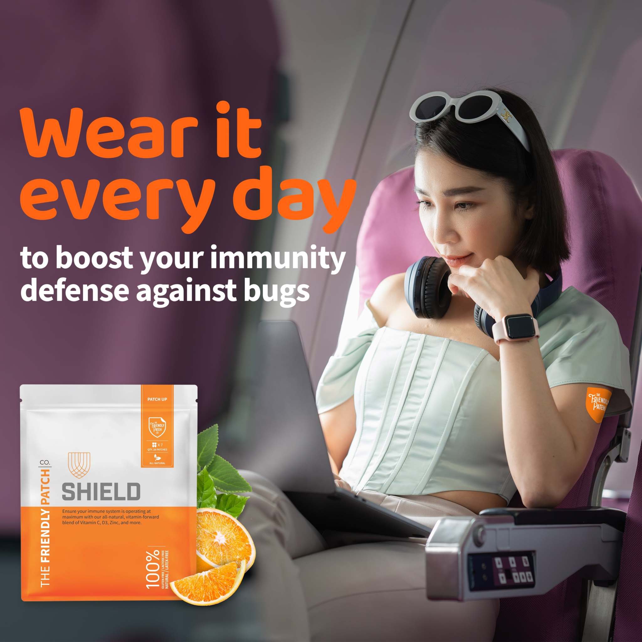 Shield Wellness Patches package in white and orange with shield logo and citrus imagery, shown beside a woman