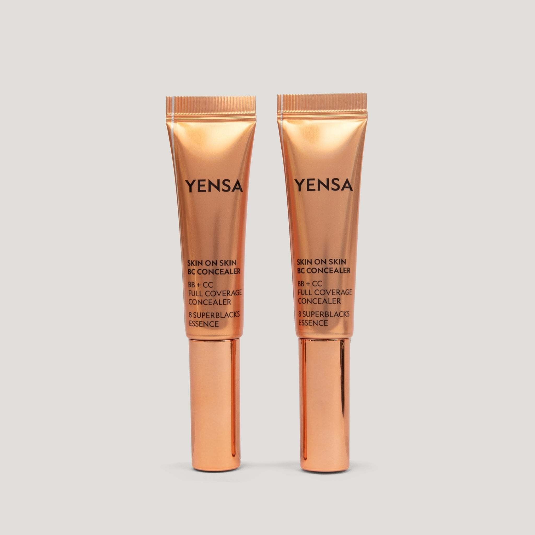 Skin On Skin BB concealer in two metallic peach squeeze tubes with black branding and narrow applicator tips.