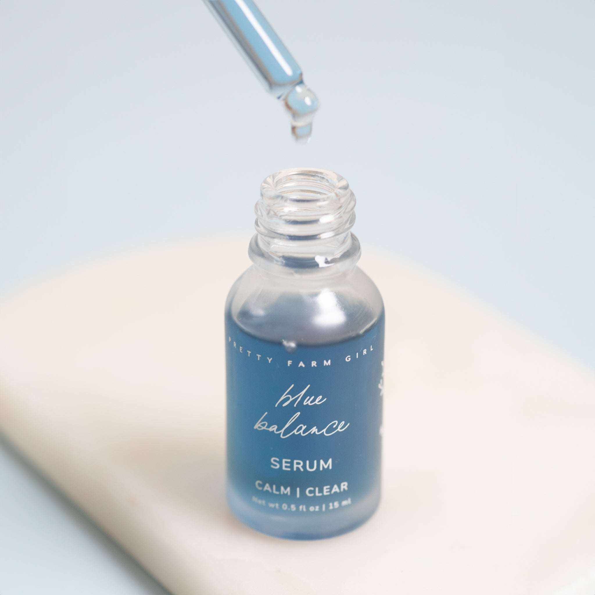 Skin Redness Skincare Routine Kit blue glass serum bottle with dropper and blue balance label lettering