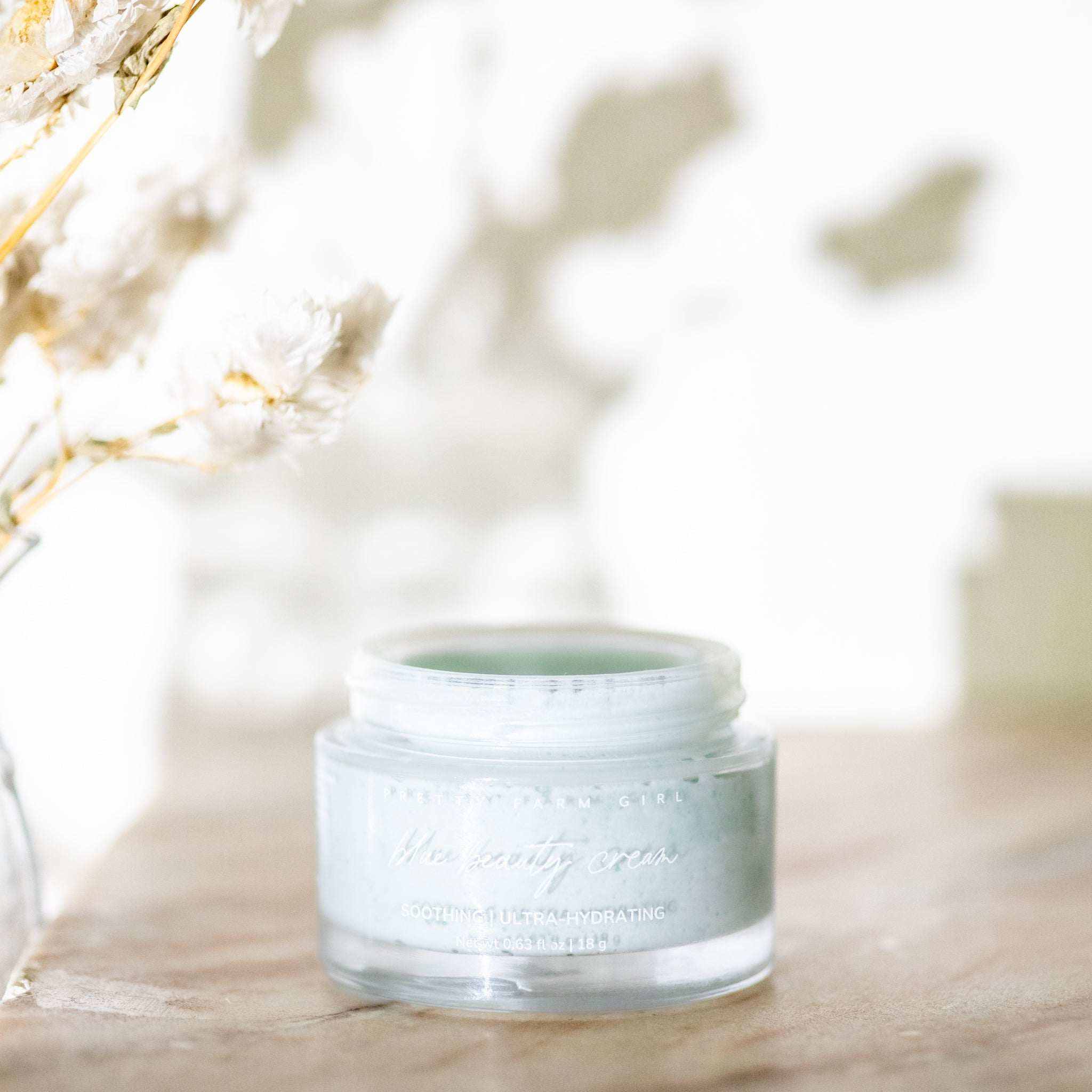 Skin Redness Skincare Routine Kit featuring a frosted glass jar of pale blue beauty cream with a silver lid