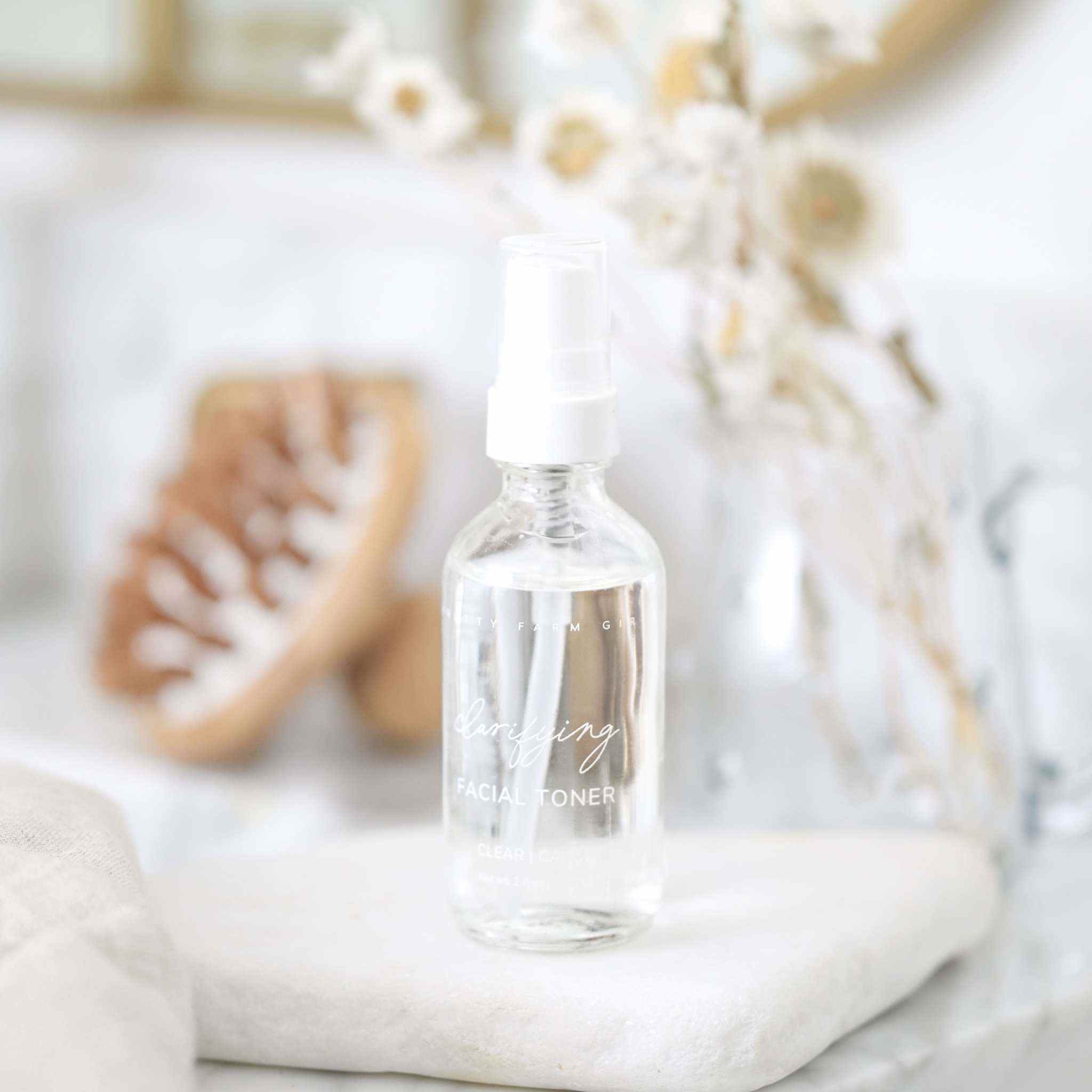 Skin Redness Skincare Routine Kit featuring a clear glass facial toner bottle with white spray pump and minimalist label