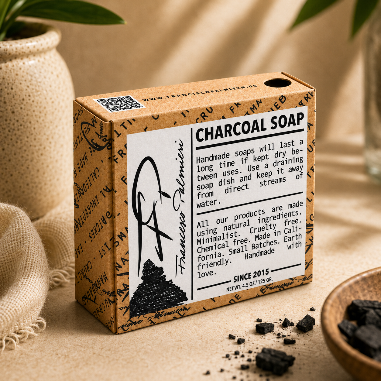 SOAP BAR - CHARCOAL in a kraft paper box labeled charcoal soap, with black charcoal pieces and a minimalist design.