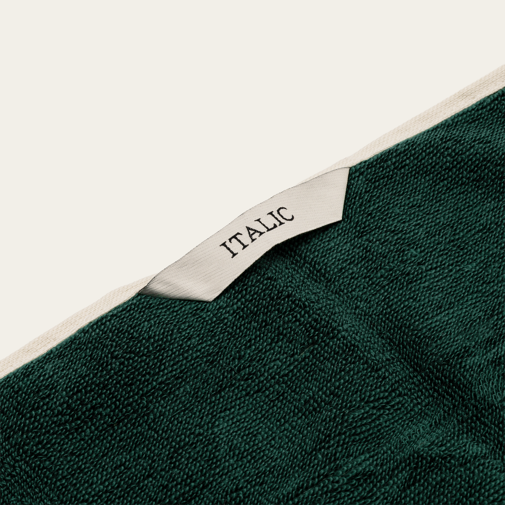 Sorrel Australian Cotton towel in deep green textured fabric, finished with a cream woven label marked “ITALIC”.