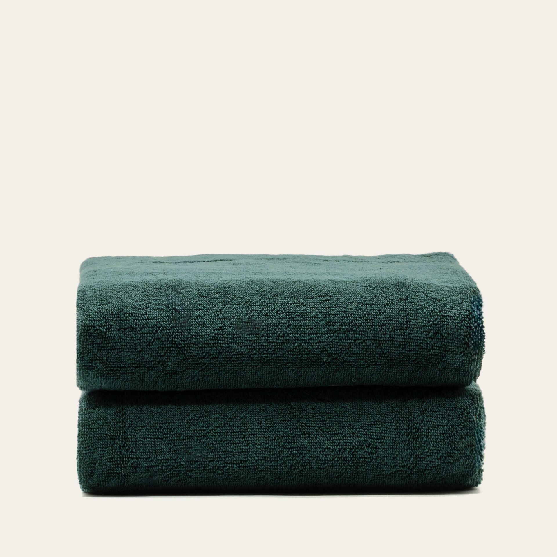Sorrel Australian Cotton towels in deep teal with a plush textured weave, stacked in two folded layers