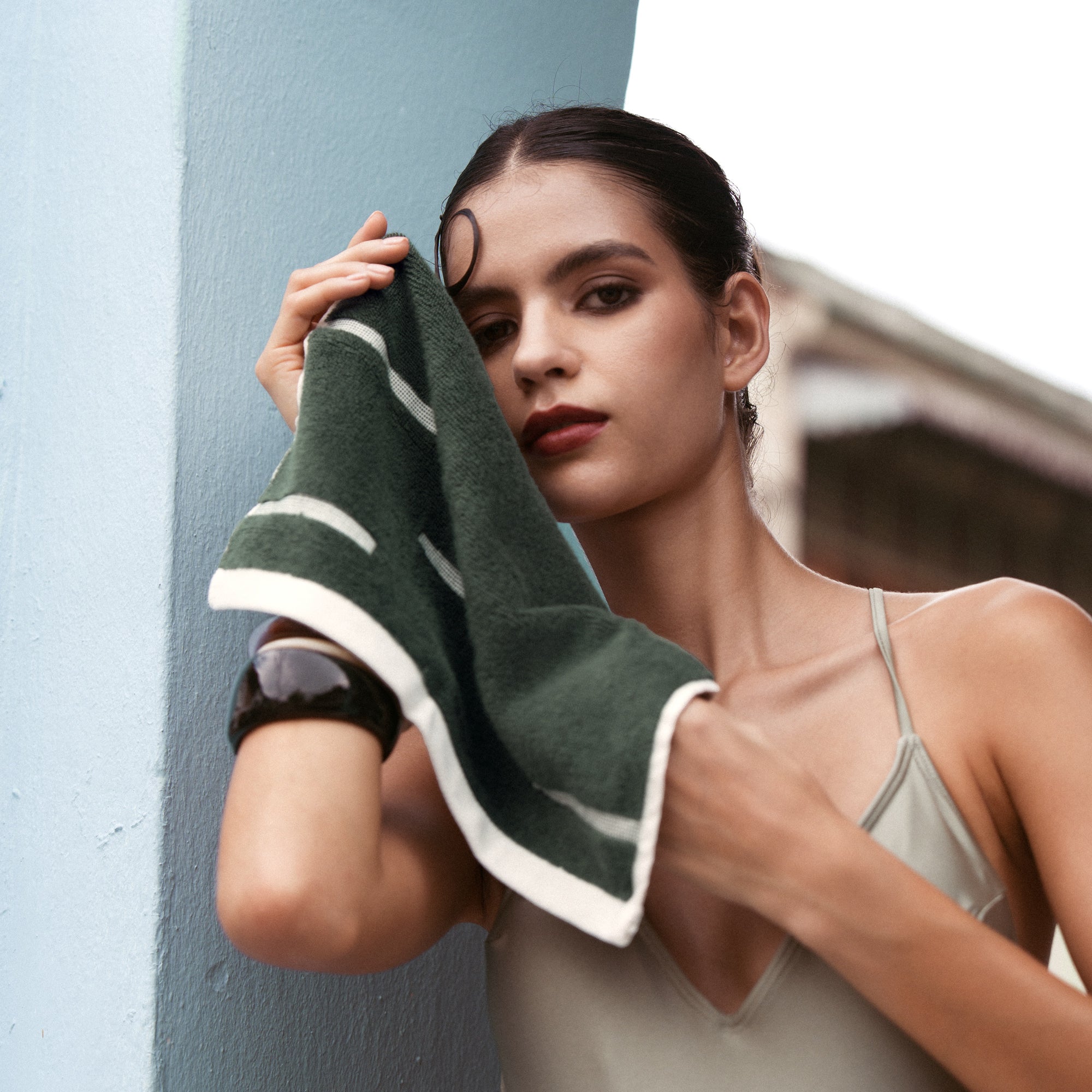 Sorrel Australian Cotton towel in deep green with bold white geometric stripes and a plush textured finish