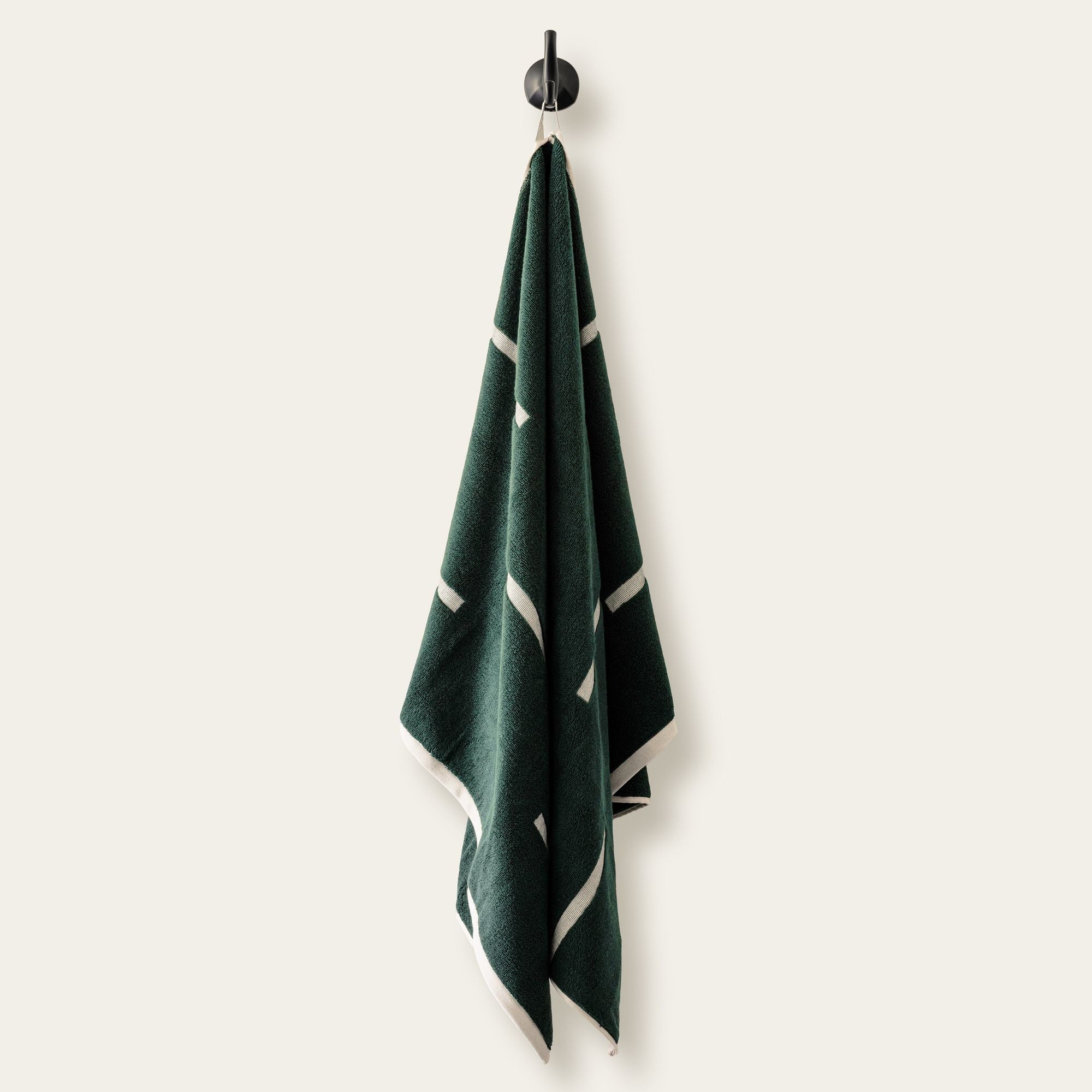 Sorrel Australian Cotton towel in deep green with cream geometric stripes, soft cotton texture and a matching edge.