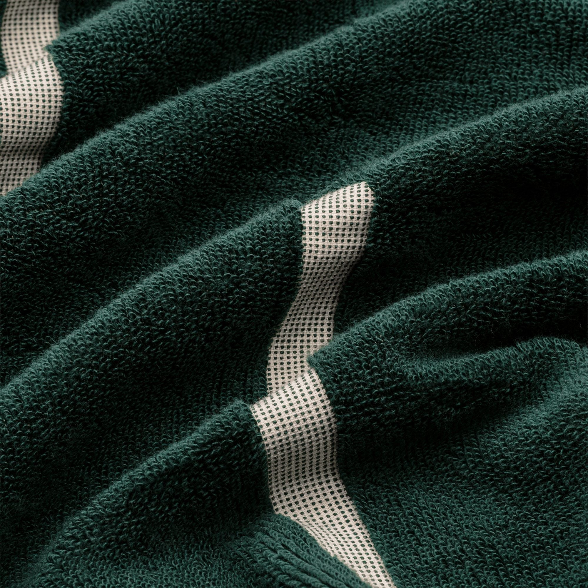 Sorrel Australian Cotton towel in deep green plush cotton with a cream geometric stripe running through the textured pile