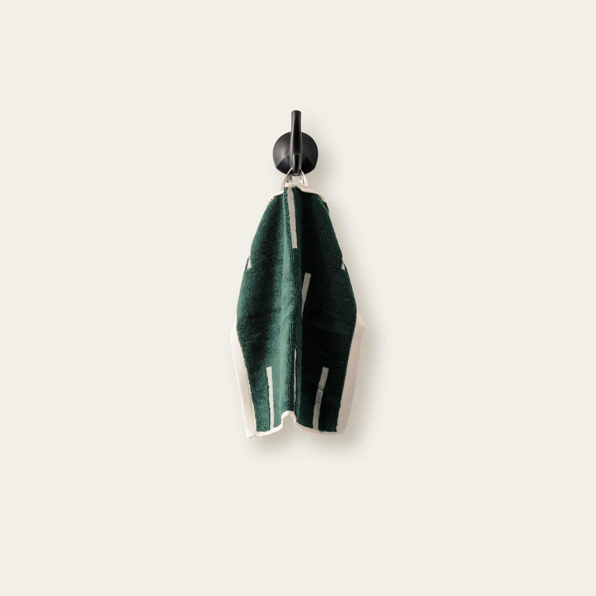 Sorrel Australian Cotton towel in deep green with soft cotton pile, geometric cream stripes and a hanging loop