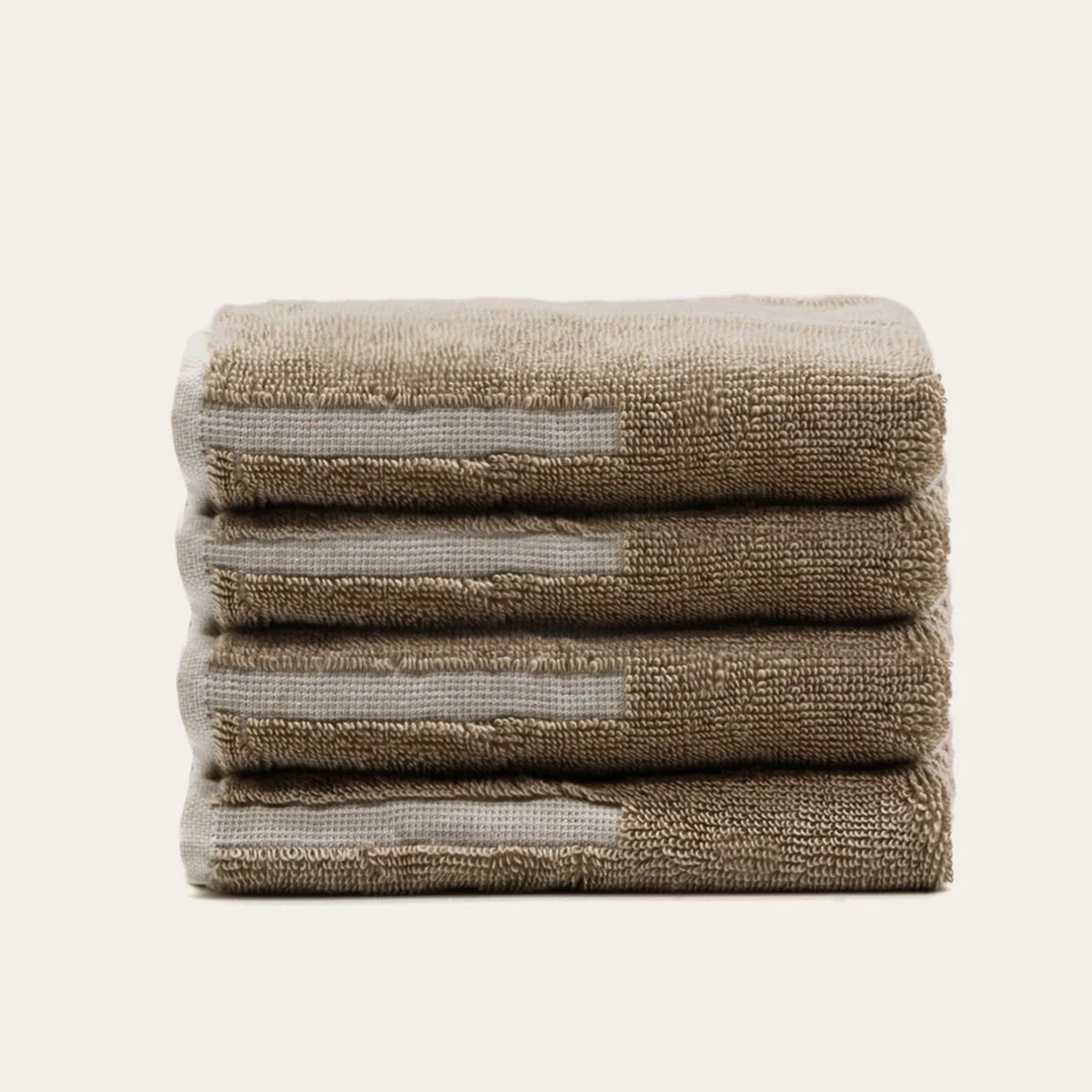 Sorrel Australian Cotton towels in warm sand beige, plush terry fabric with pale geometric stripe accents
