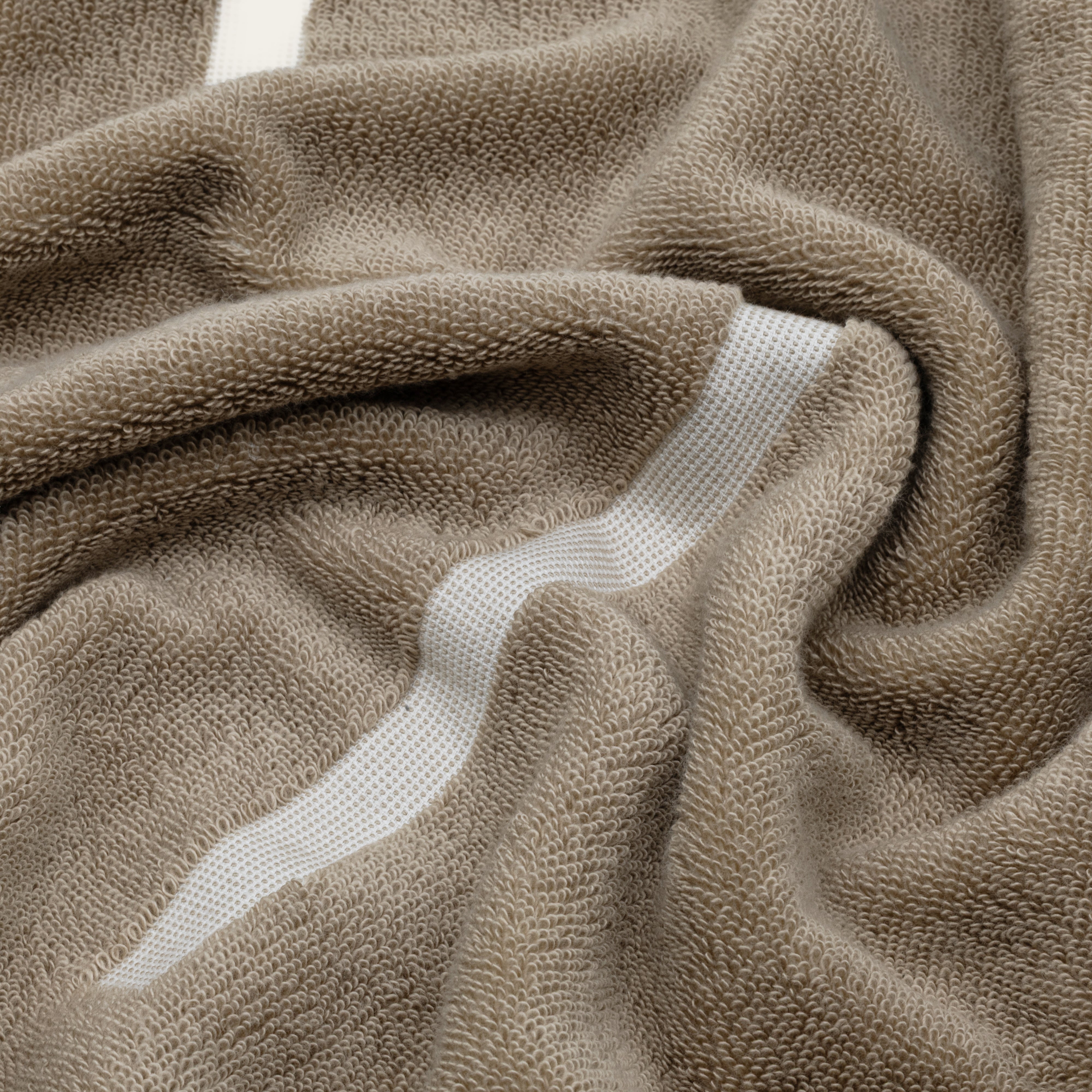 Sorrel Australian Cotton towel in warm taupe with a plush woven texture and a white geometric stripe detail