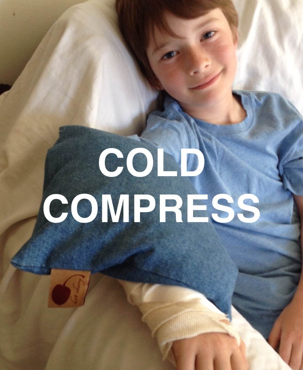 Summer Stack denim cold compress pillow in dark blue fabric with a soft square shape and tan tag