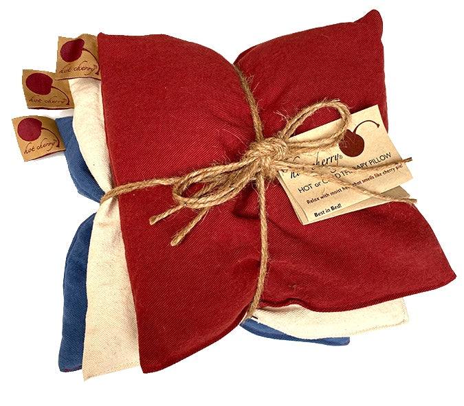 Summer Stack square denim pillows in red, blue and natural, tied together with rustic twine and product tags