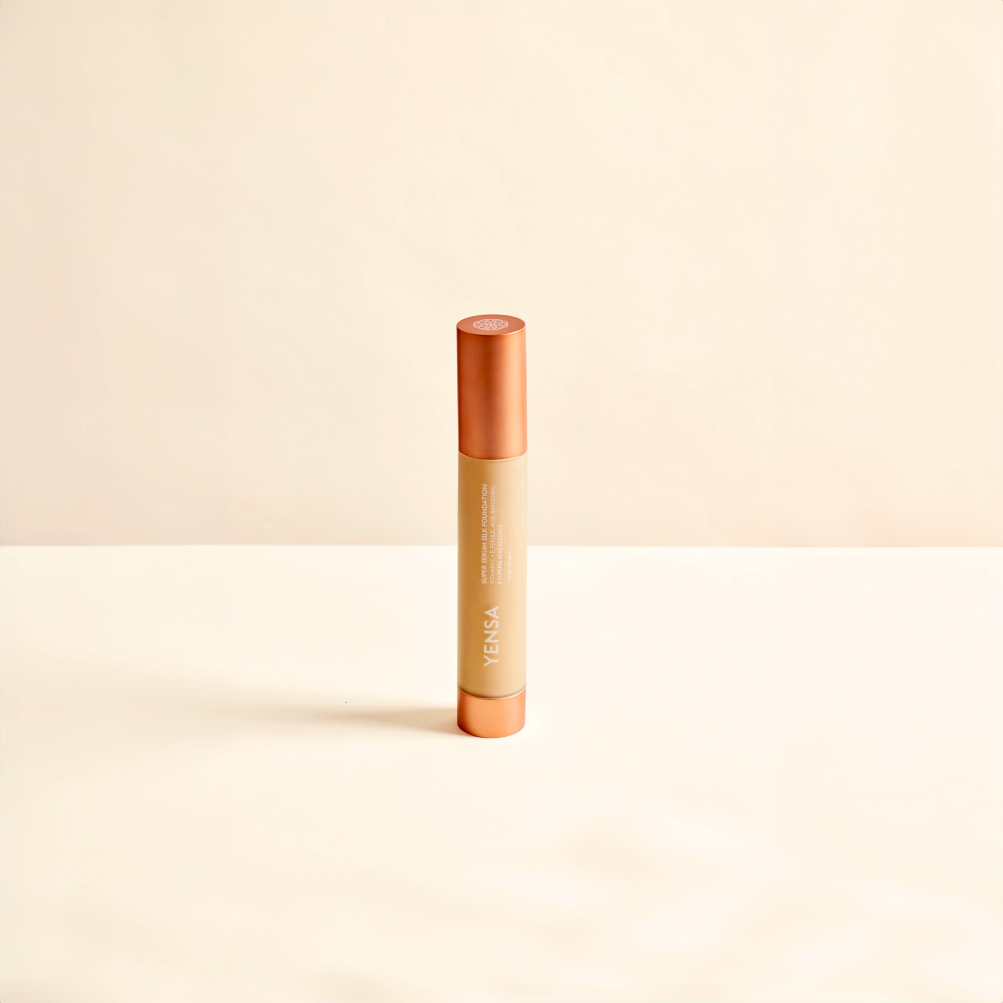 Super Serum Silk foundation in a slim beige tube with copper-orange ends and white vertical lettering