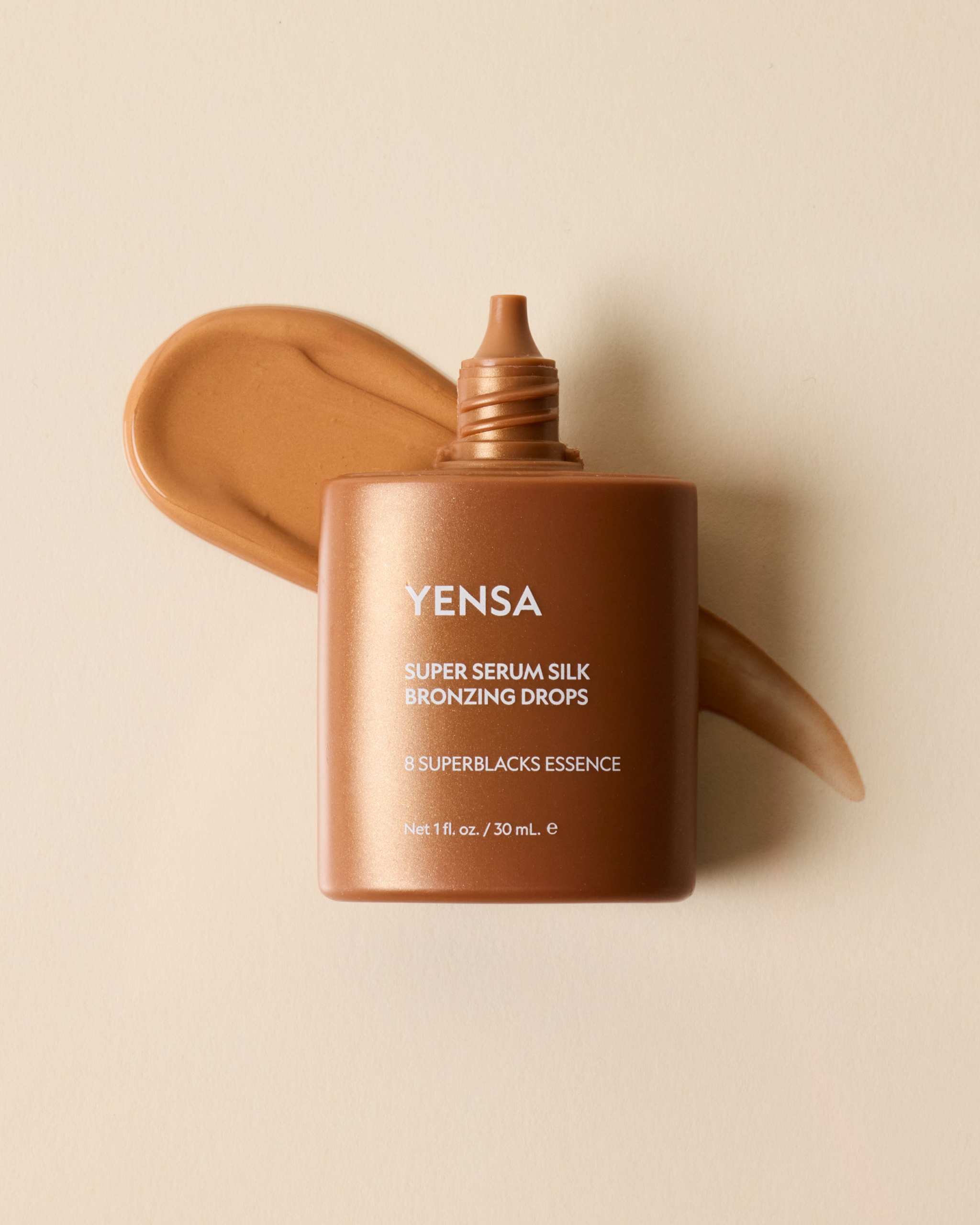 Super Serum Silk Bronzing Drops in a warm bronze squeeze bottle with an open nozzle and matching swatch