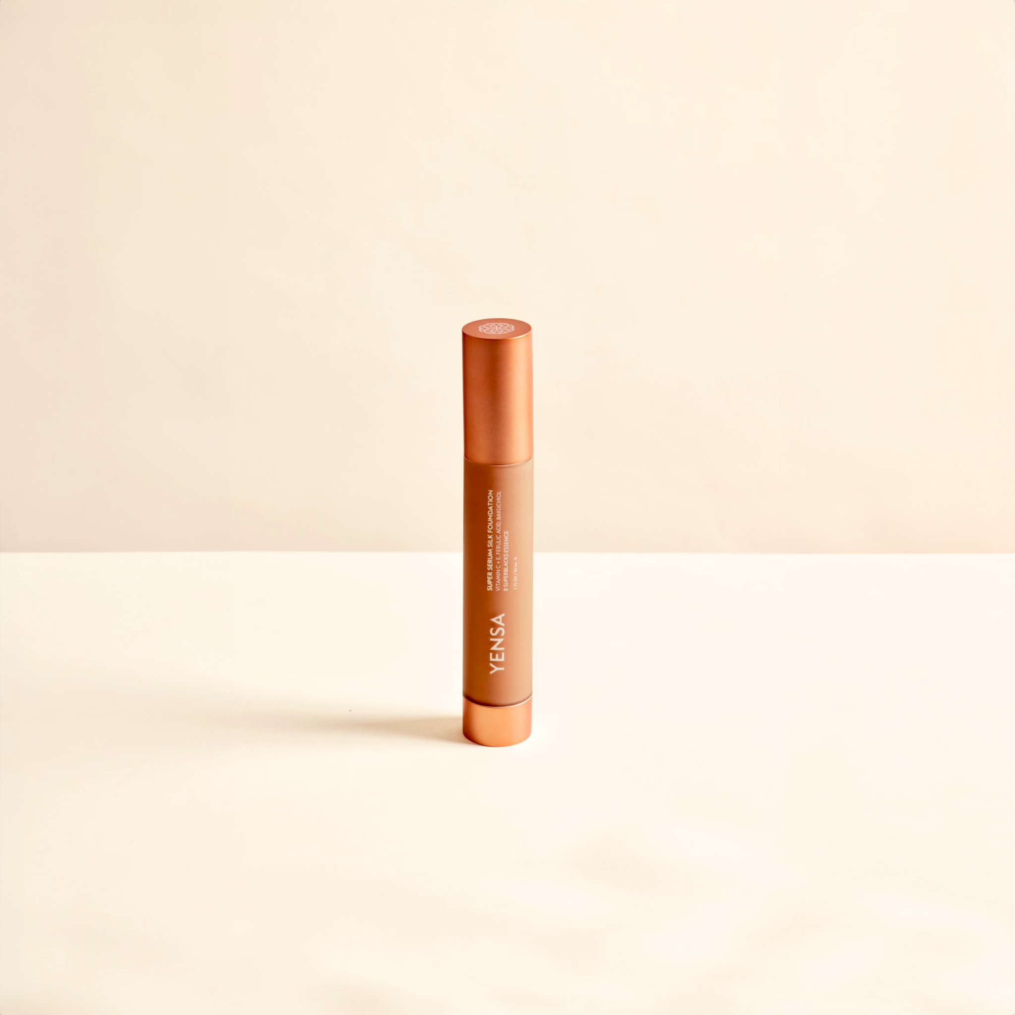 Super Serum Silk foundation in a slim copper-toned tube with a matching cap and white vertical branding