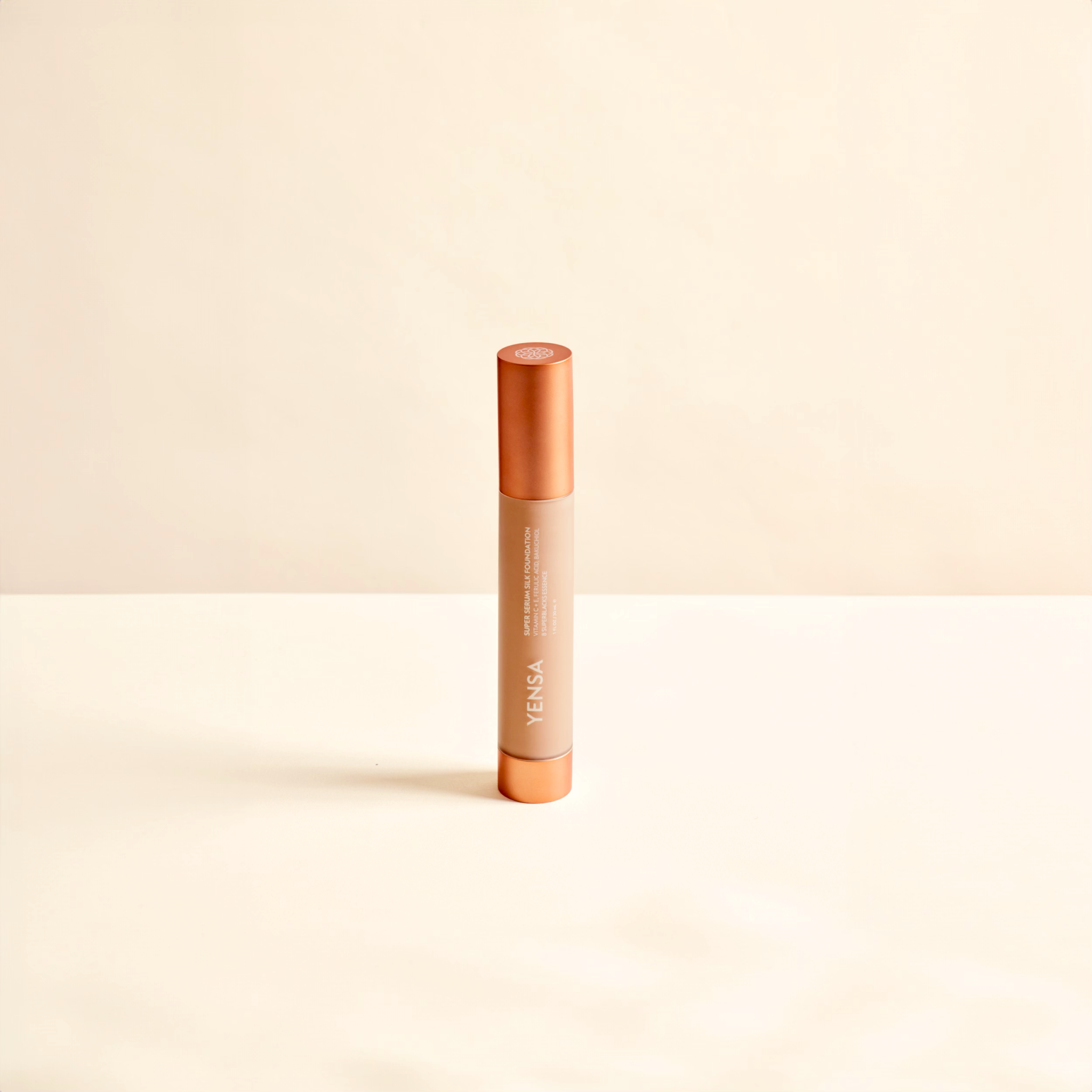 Super Serum Silk foundation in a slim peach and copper tube with a minimalist design and cylindrical cap