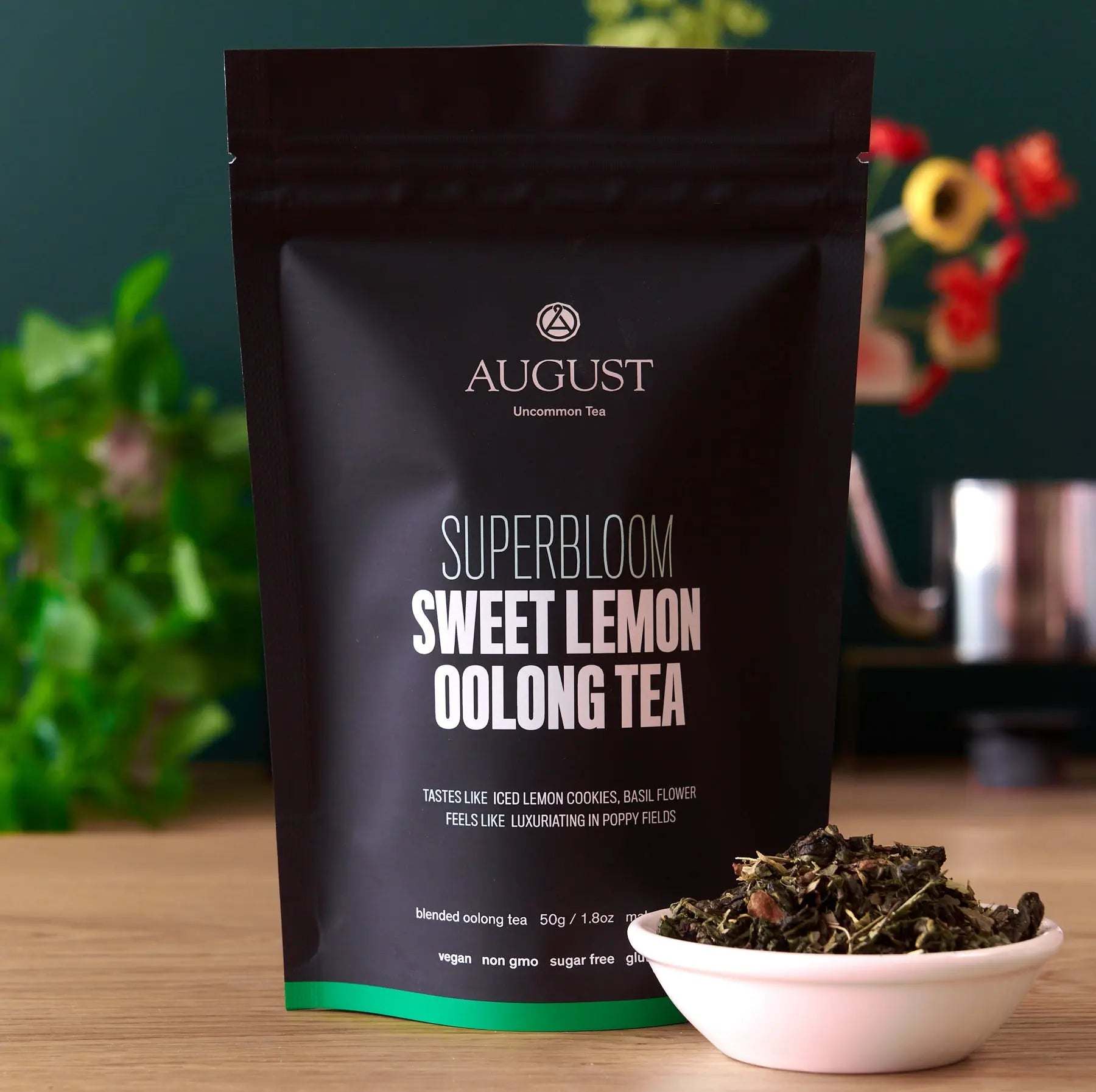 Superbloom - Sweet Lemon Oolong Green Tea in a dark matte pouch with loose-leaf tea in a white bowl