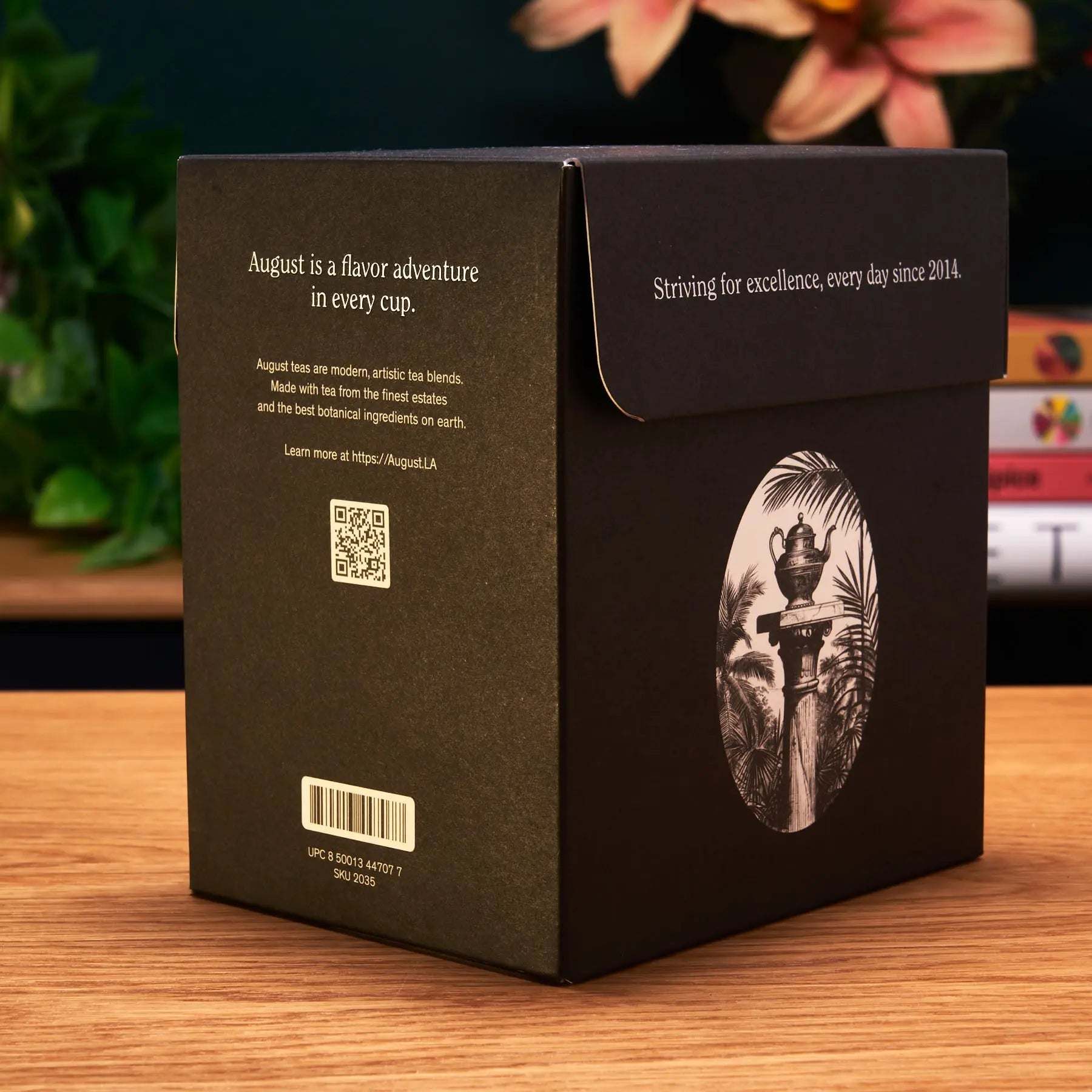 Tea sampler box in matte black packaging with a cream oval illustration, a barcode and QR code, for taste ten trending teas