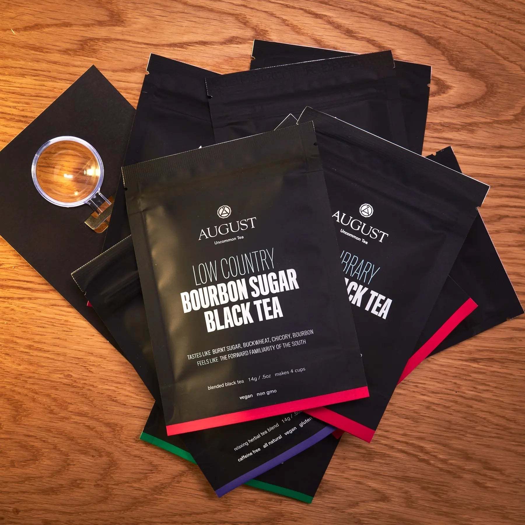 Tea sampler taste ten trending teas with black sample pouches, bold white lettering, colourful accent bands and measuring scoop