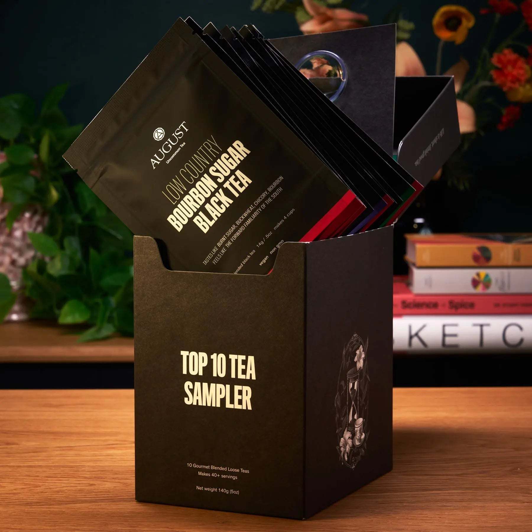 taste ten trending teas sampler with dark brown cardboard box and ten individually packaged tea samples in black pouches