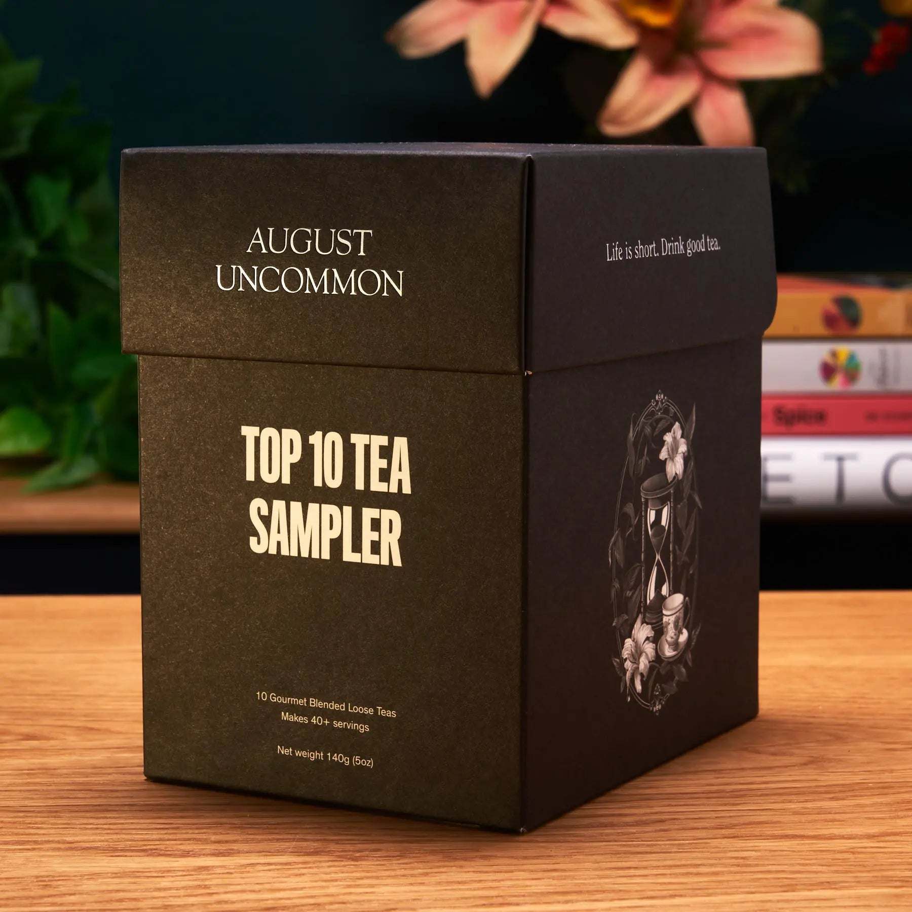 Tea sampler box in dark brown packaging with cream lettering and an illustrated side, featuring taste ten trending teas